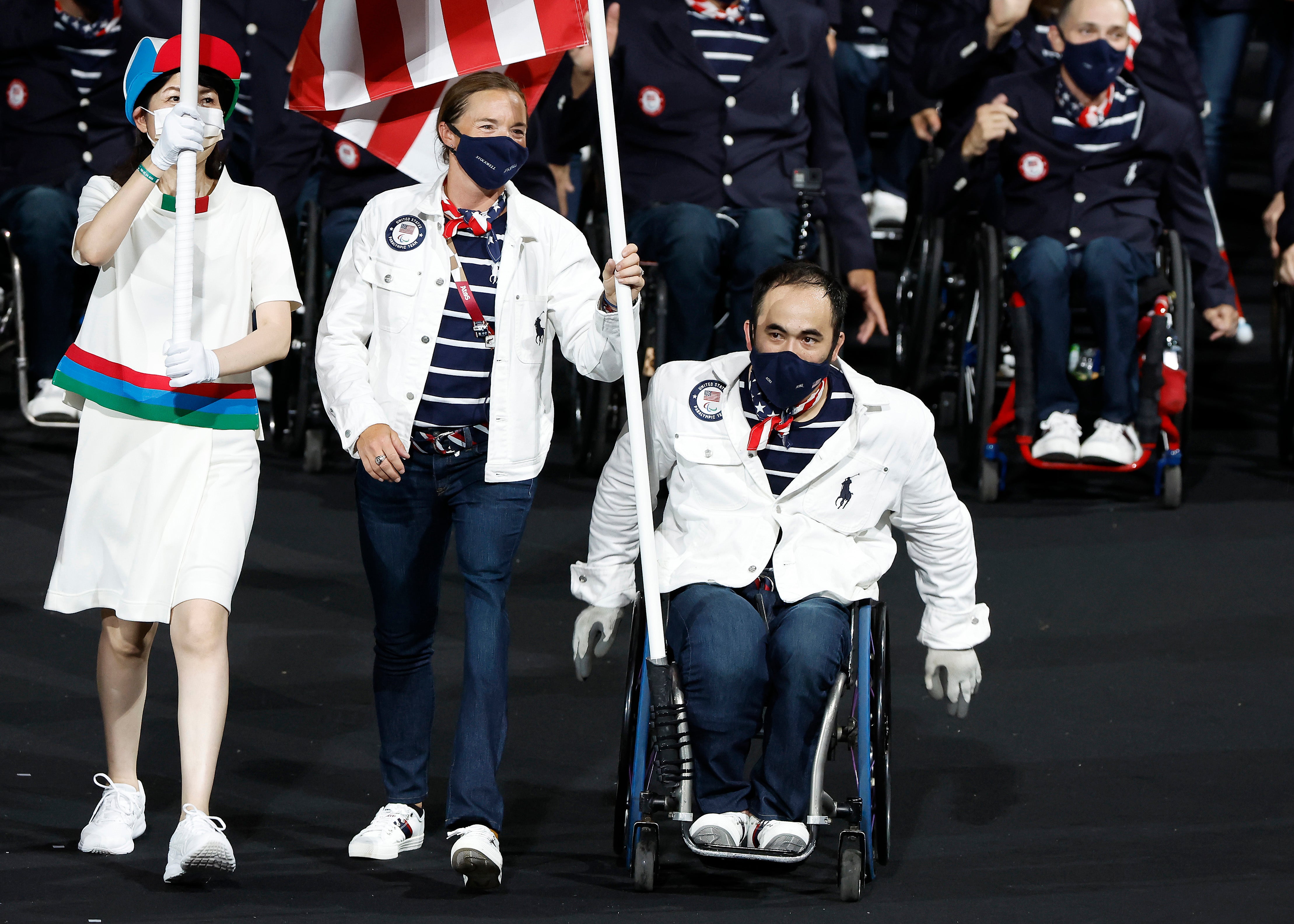 Flag bearers Melissa Stockwell and Charles Aoki of Team United States lead their delegation in the parade of athletes during the opening ceremony of the Tokyo 2020 Paralympic Games at the Olympic Stadium on August 24, 2021 in Tokyo, Japan.