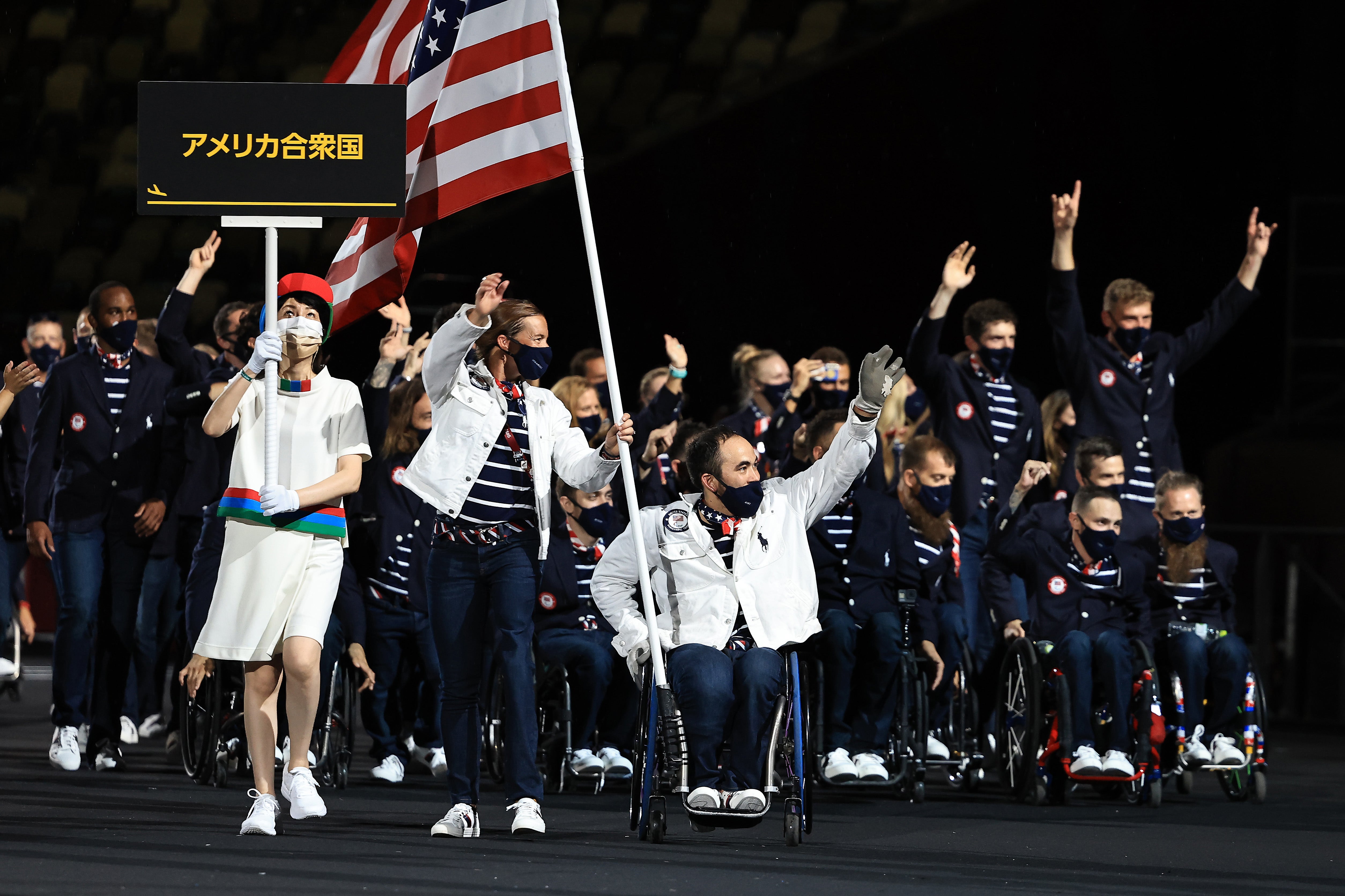 Flag bearers Melissa Stockwell and Charles Aoki of Team United States lead their delegation in the parade of athletes during the opening ceremony of the Tokyo 2020 Paralympic Games at the Olympic Stadium on August 24, 2021 in Tokyo, Japan.