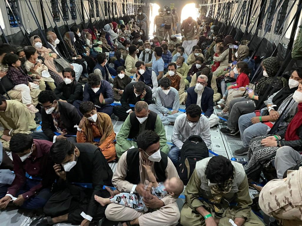 Afghan aboard a military plane as part of their evacuation from Kabul on Wednesday