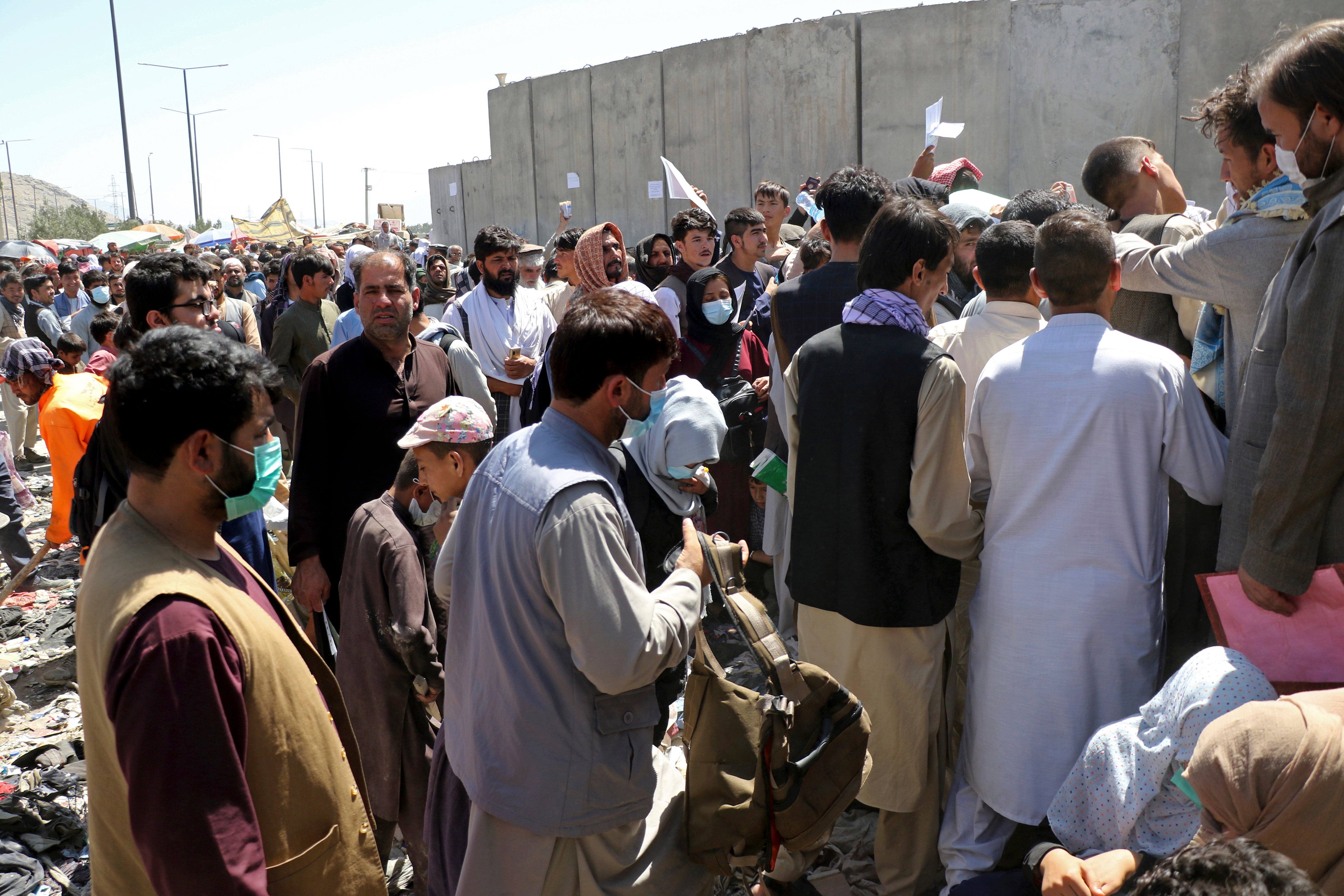 Hundreds of people gathered outside Hamid Karzai International Airport, in Kabul after the city was retaken by the Taliban