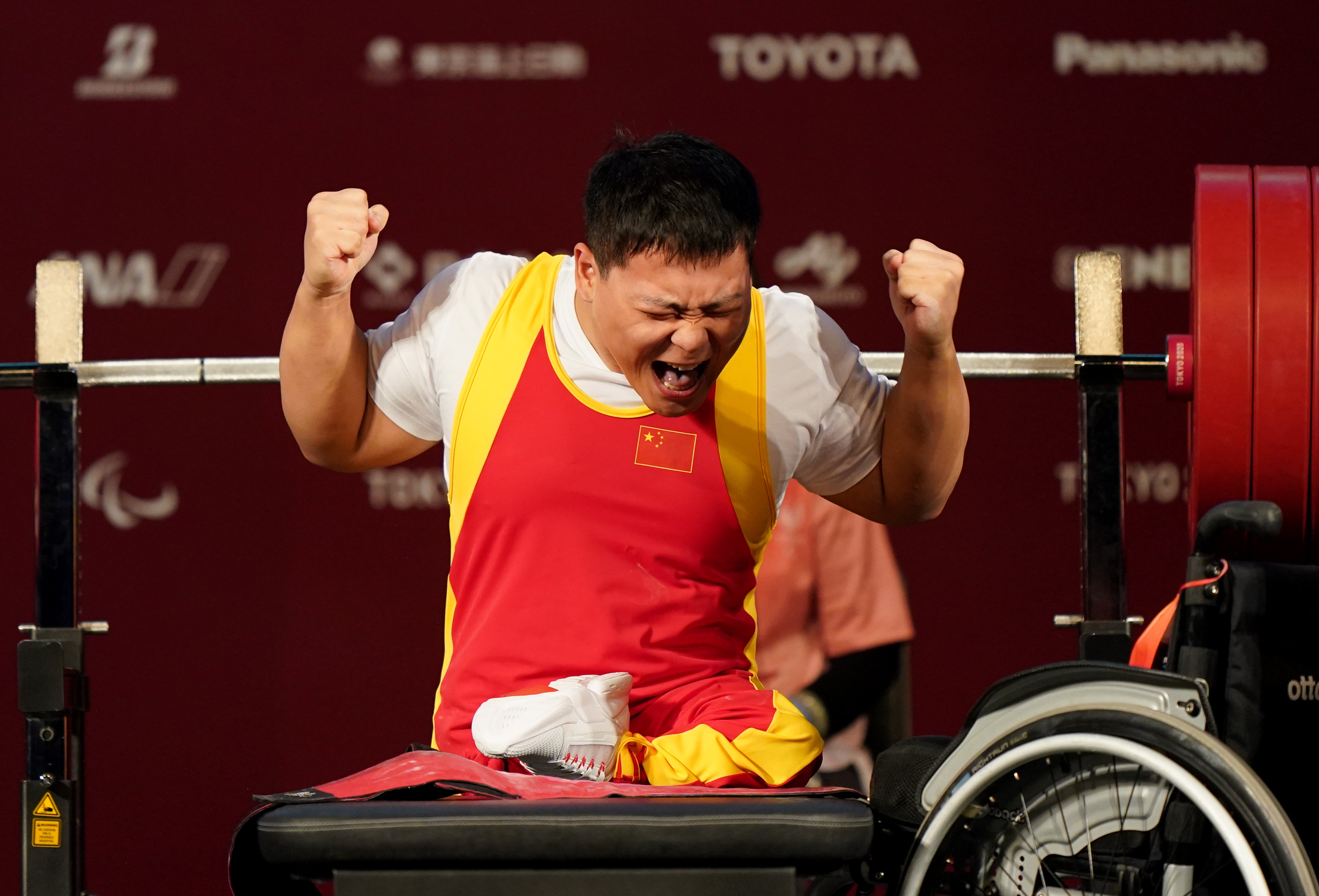 China’s Qi Yongkai struggles to contain his delight after the third lift in the Men’s -59 kg Final (Tim Goode/PA)