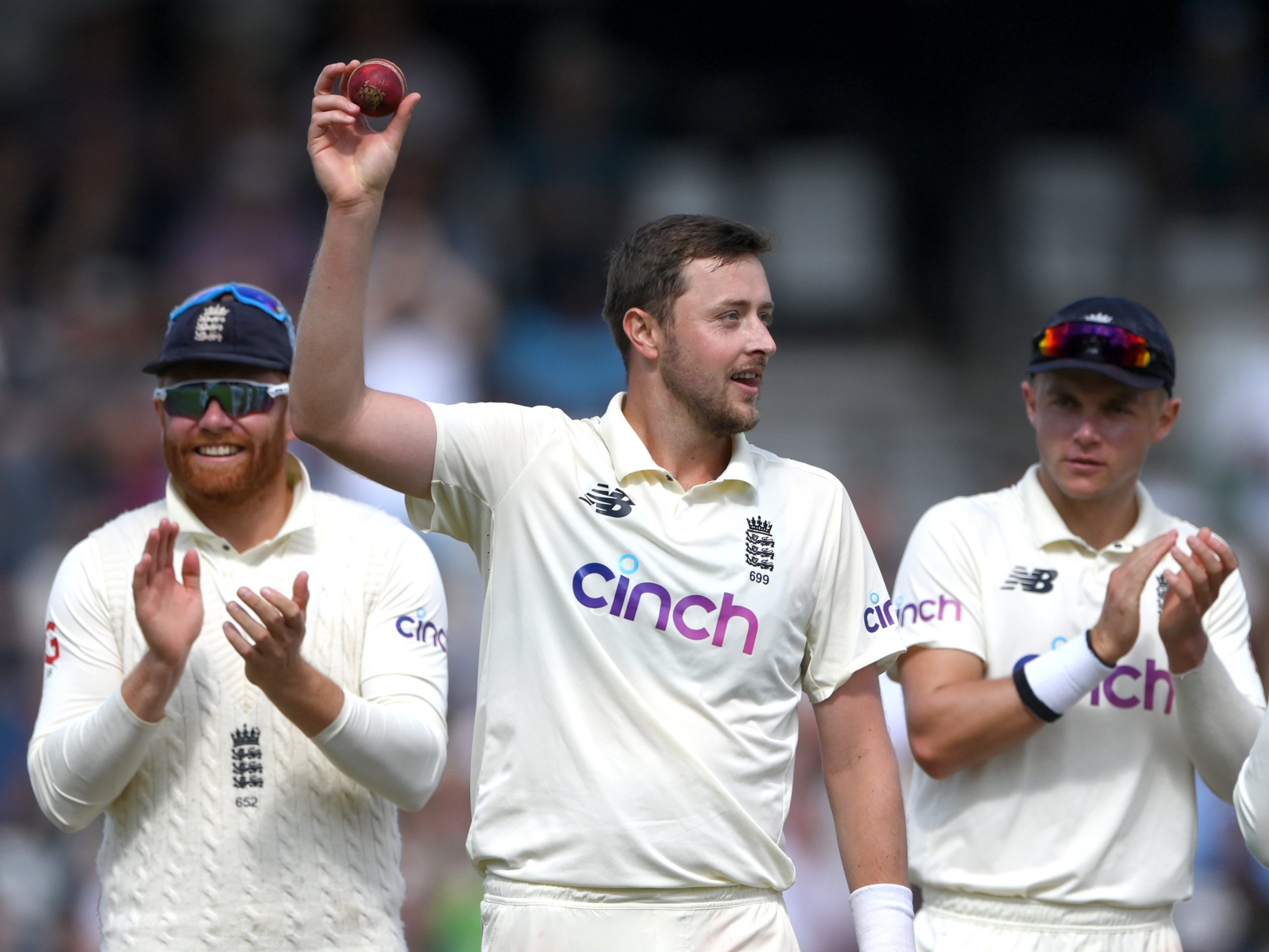 England bowler Ollie Robinson holds aloft the ball after taking his five wickets in the second innings