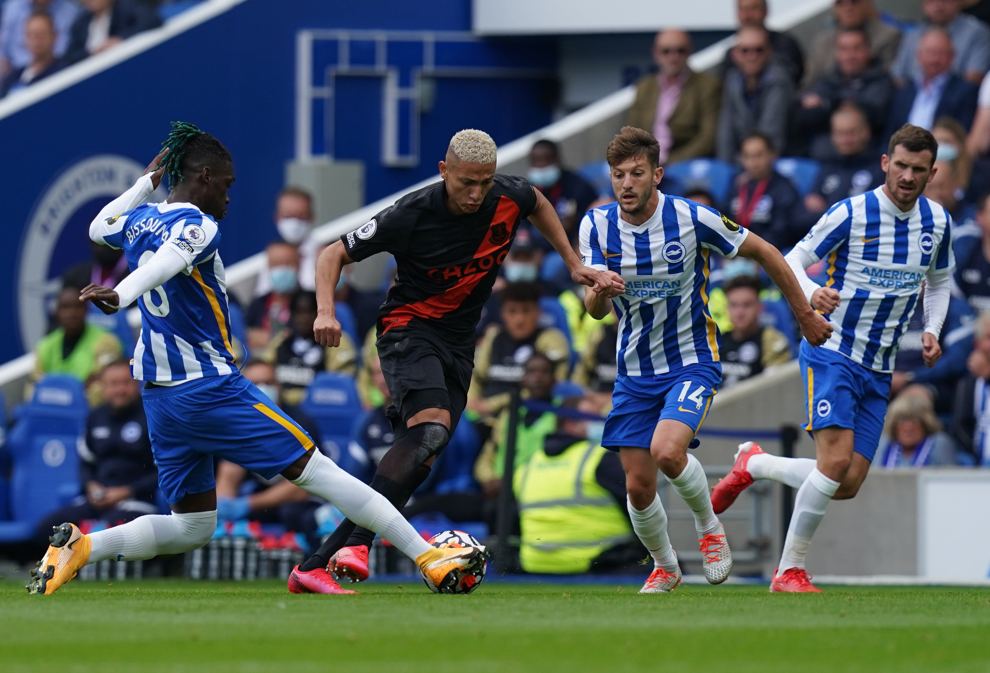 Richarlison (centre) dribbles past Brighton’s Yves Bissouma (Gareth Fuller/PA)