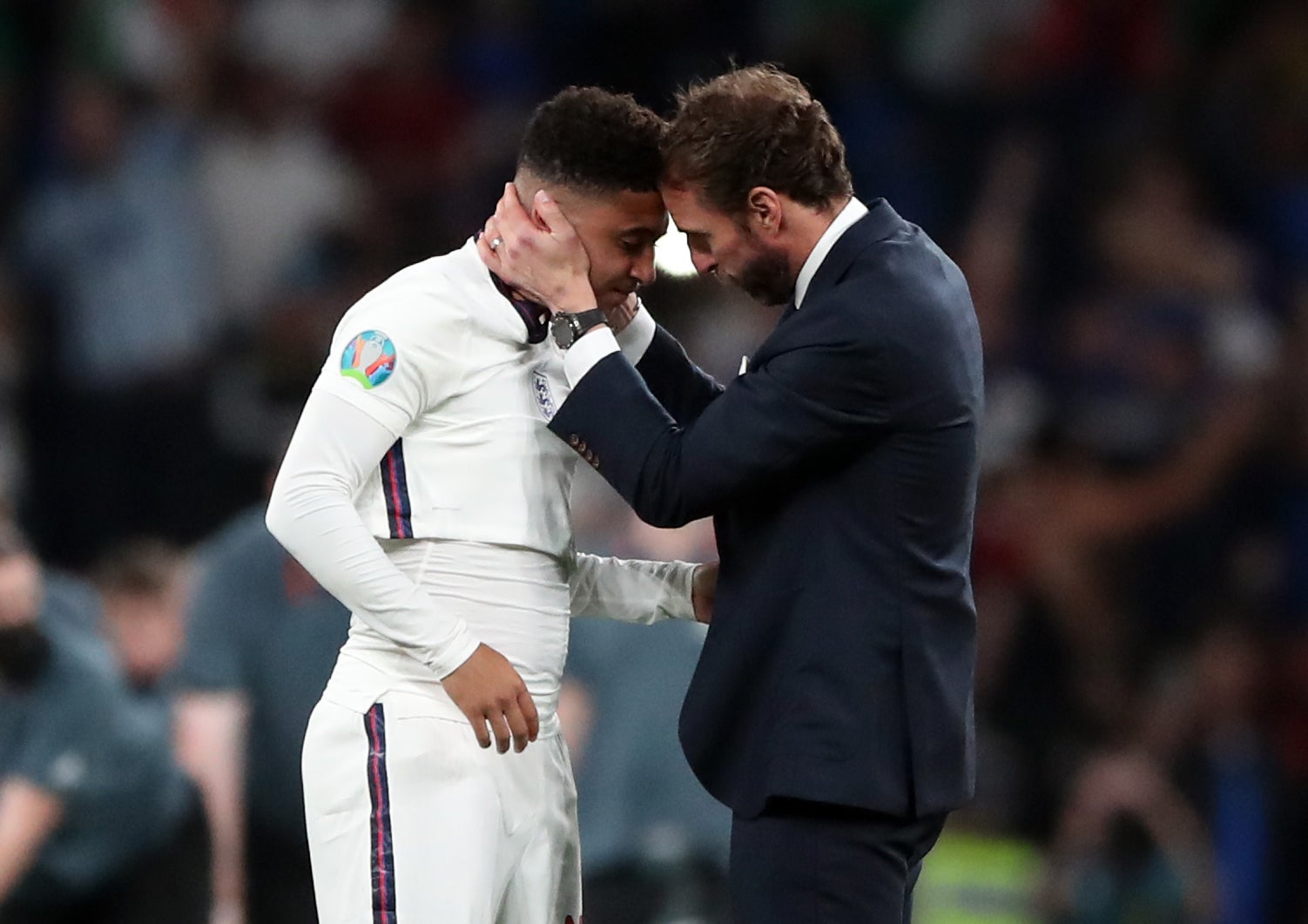 England manager Gareth Southgate consoles Jadon Sancho following defeat in the penalty shoot-out against Italy in the Euro 2020 Final at Wembley (Nick Pots/PA Images).