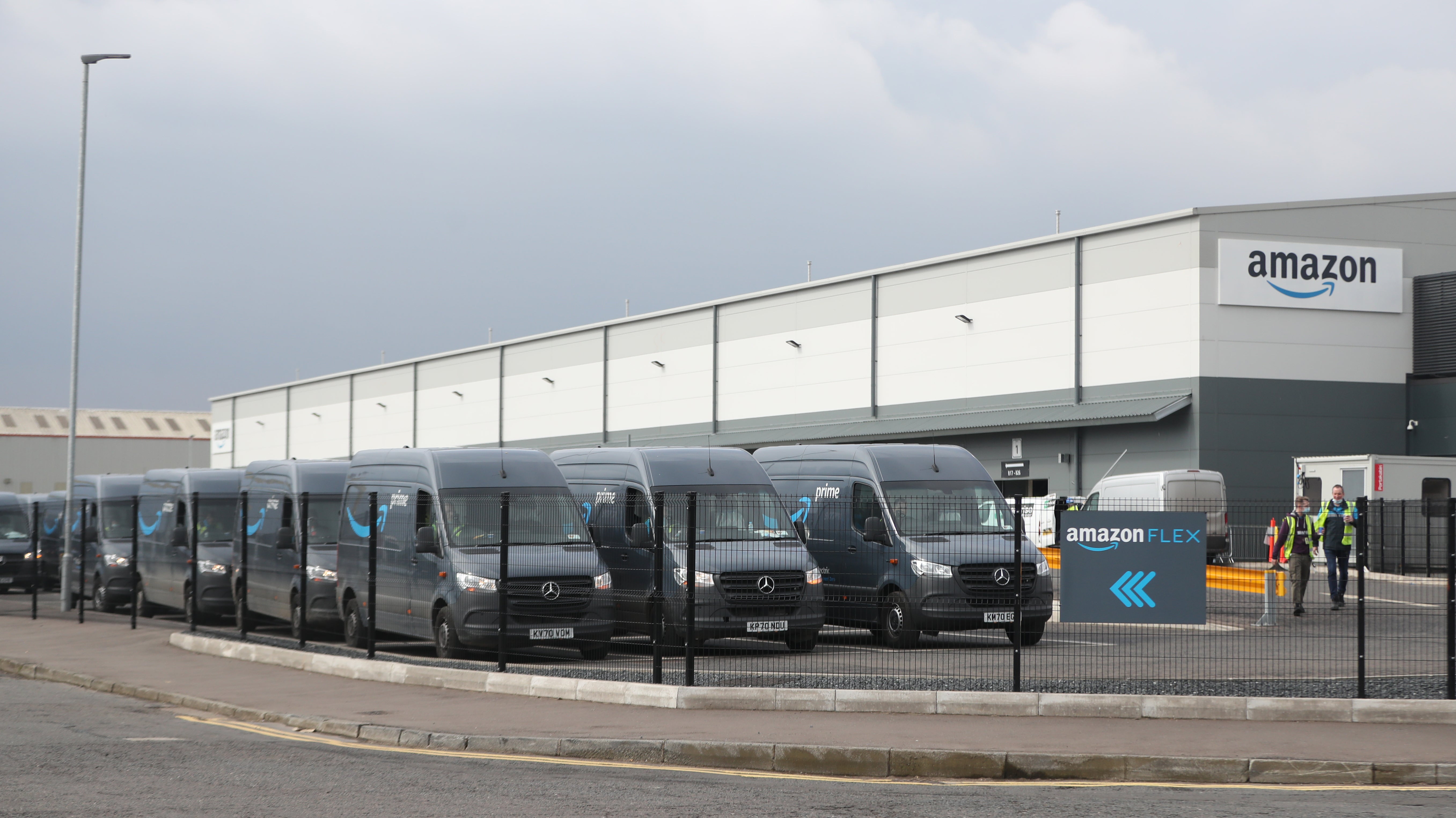 Electric delivery vans at the Amazon warehouse in the Titanic Quarter, Belfas (Niall Carson/PA)