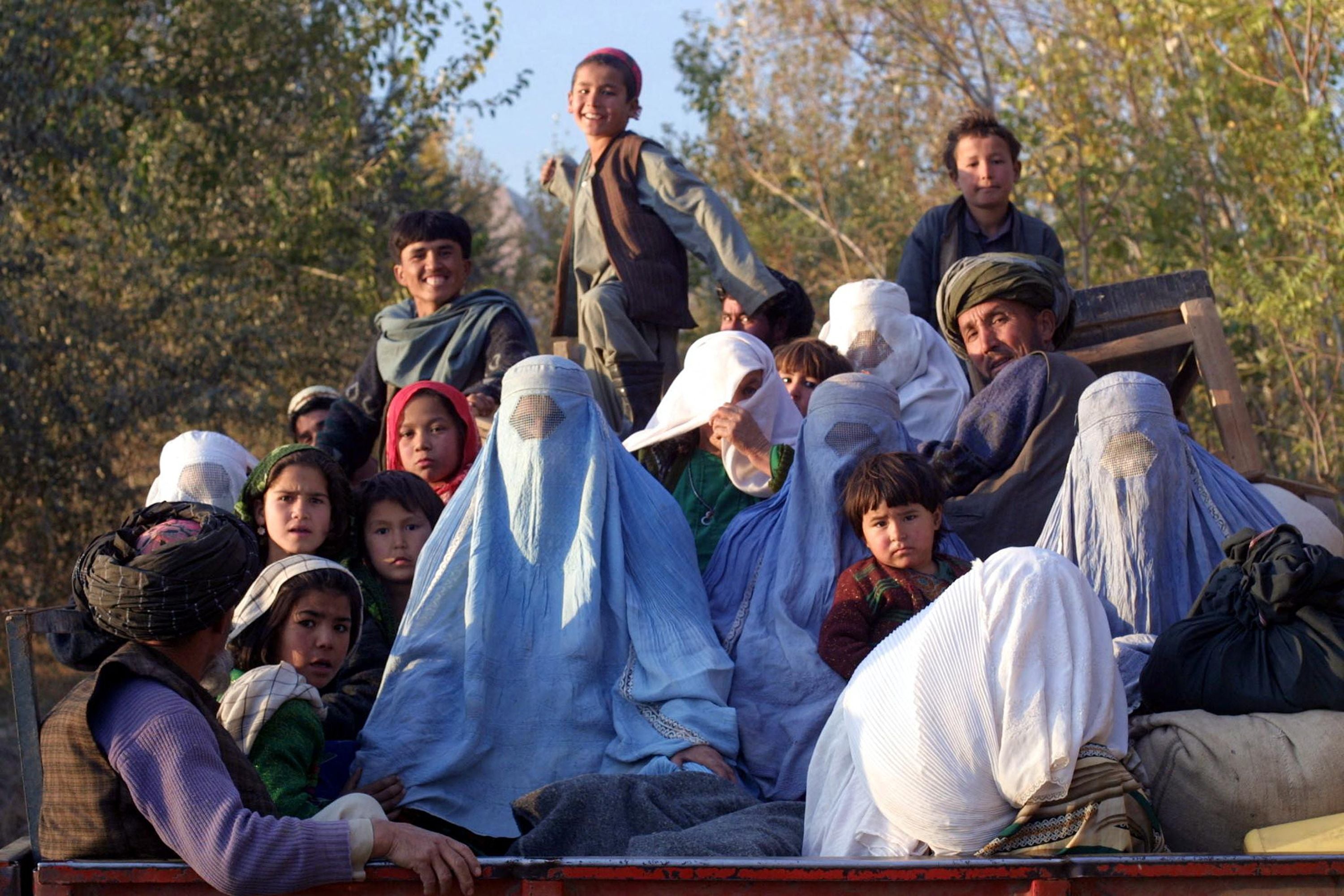 Kalaqata residents, in the Takhar province, fleeing the frontline as US fighter planes bomb Taliban positions in November 2001