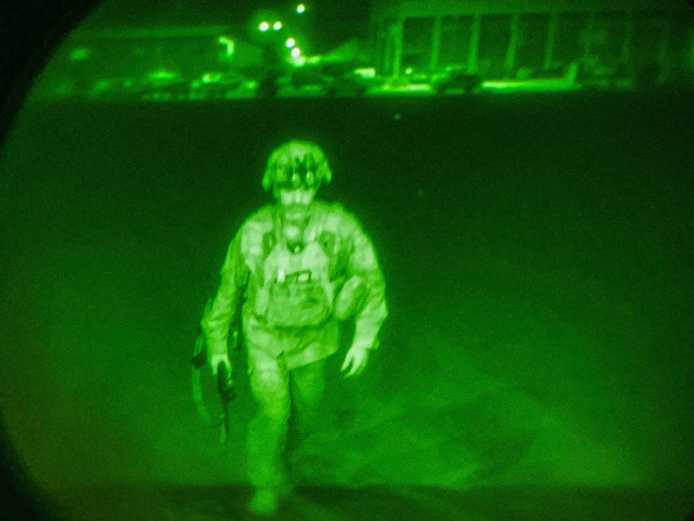 In this image made through a night vision scope and provided by U.S. Central Command, Maj. Gen. Chris Donahue, commander of the U.S. Army 82nd Airborne Division, XVIII Airborne Corps, boards a C-17 cargo plane at Hamid Karzai International Airport in Kabul, Afghanistan, Monday, Aug. 30, 2021, as the final American service member to depart Afghanistan. (U.S. Central Command via AP)