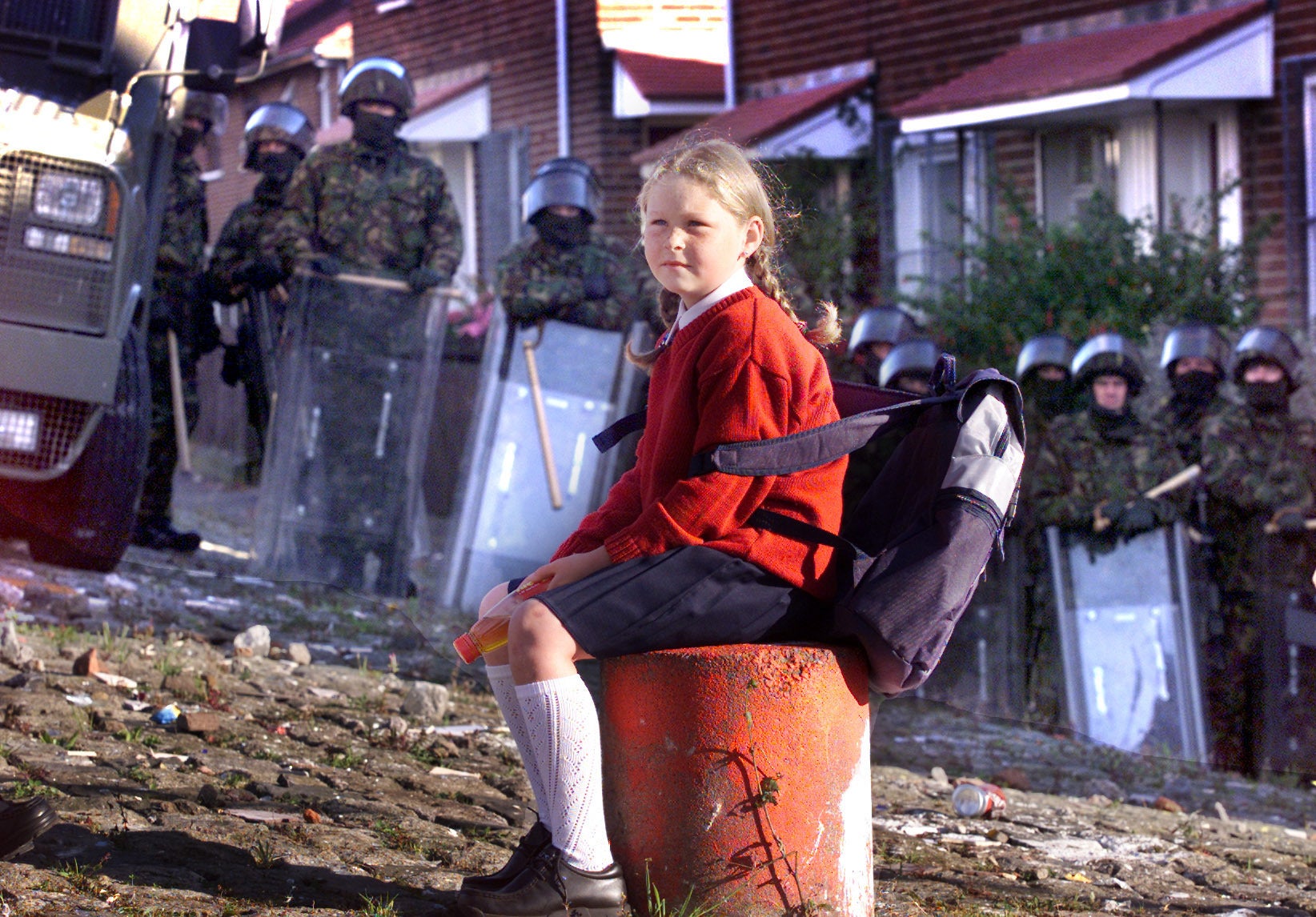 A child waits at army lines to be escorted to Holy Cross school, north Belfast