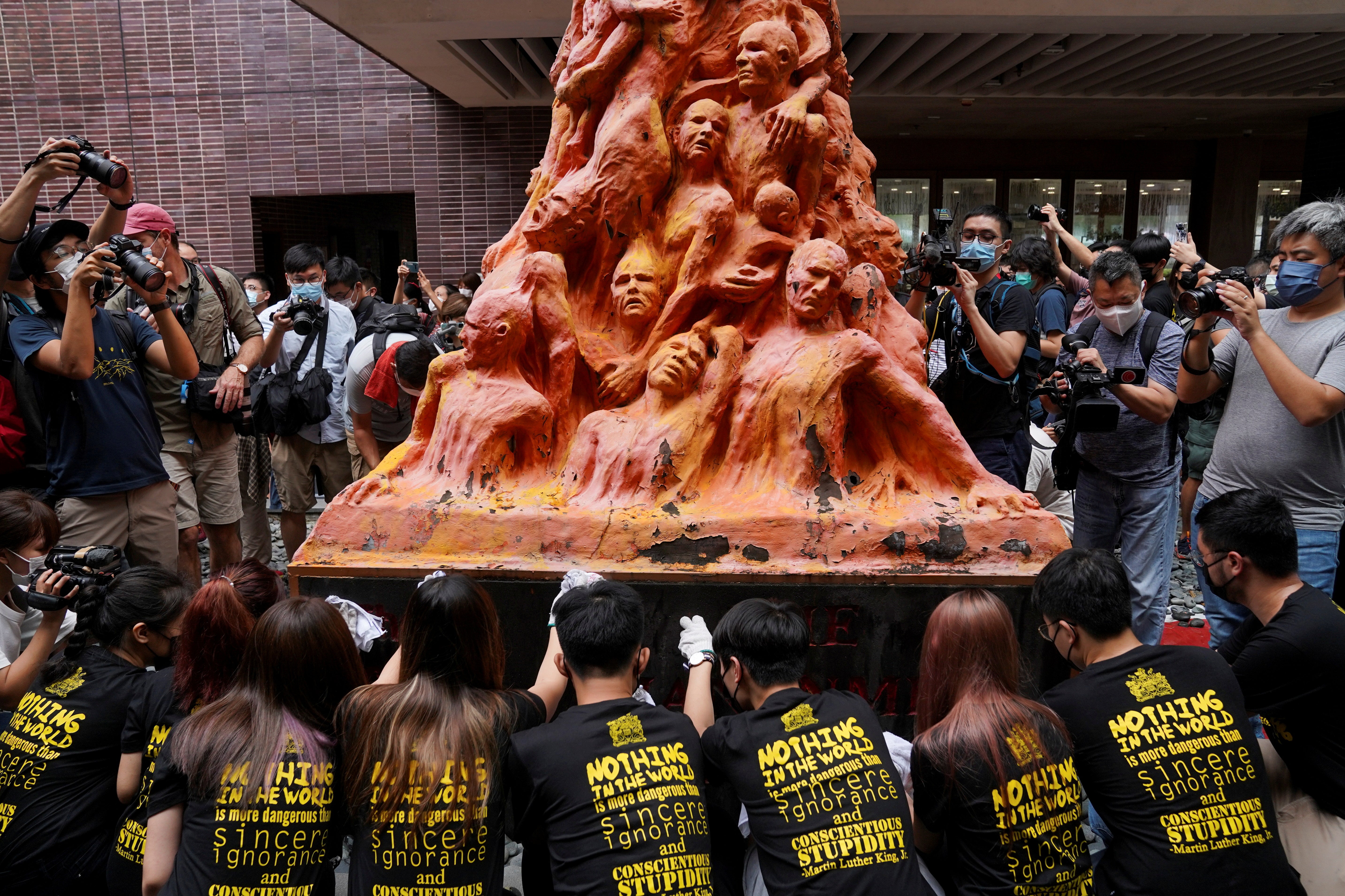 University students clean the ‘Pillar of Shame’ statue at the University of Hong Kong on the 32nd anniversary of the crackdown on pro-democracy demonstrators at Beijing’s Tiananmen Square in 1989