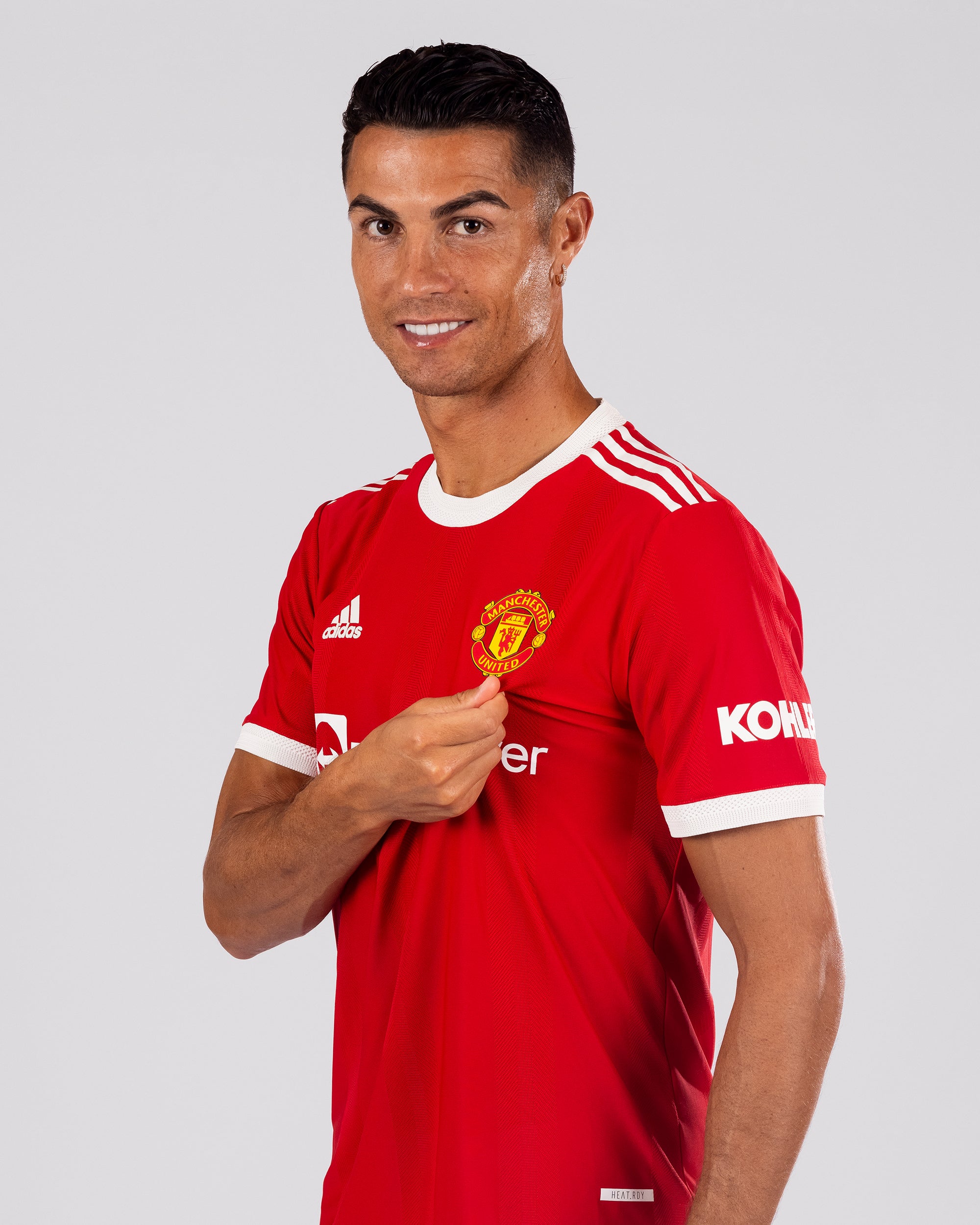 Cristiano Ronaldo of Manchester United poses after signing for the club