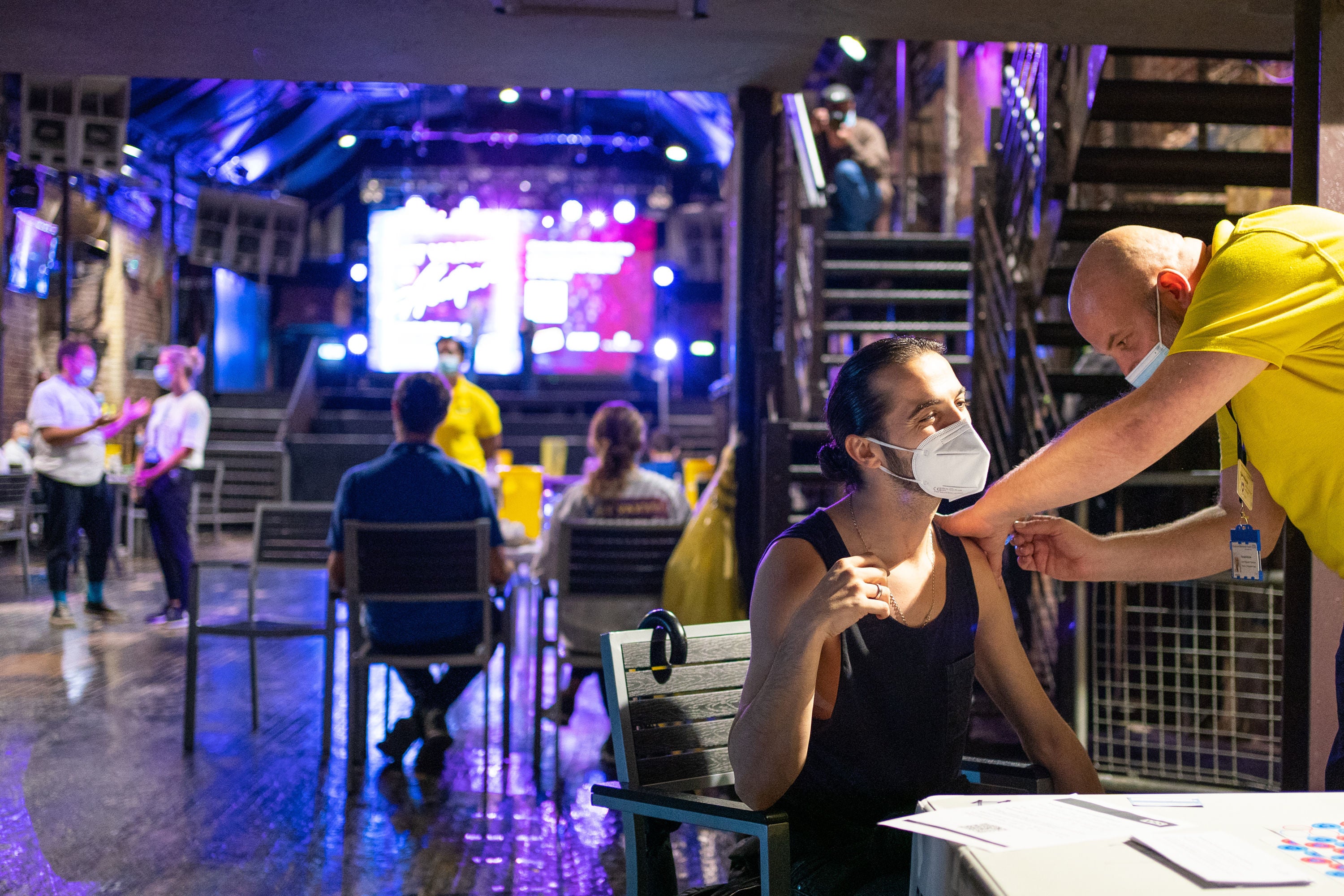 A patient receives a dose of the Pfizer/BioNTech covid vaccine at Heaven nightclub in central London