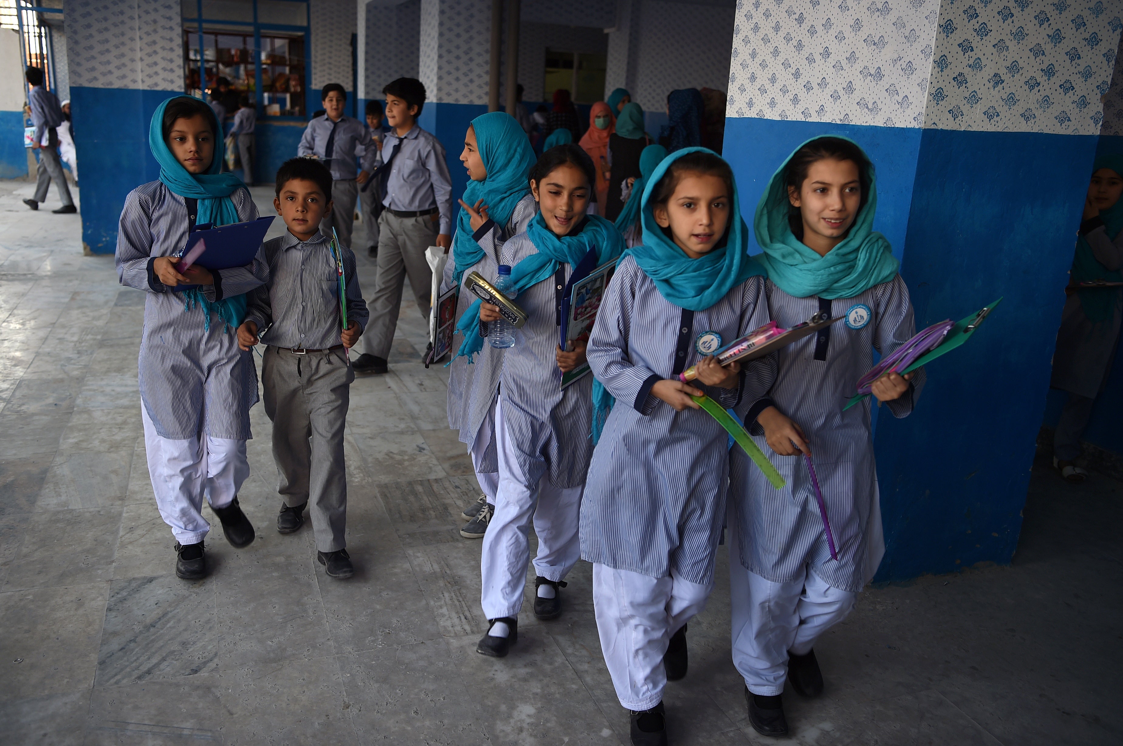 Afghan schoolgirls leave after the mid-term exams at a school in Kabul in 2019