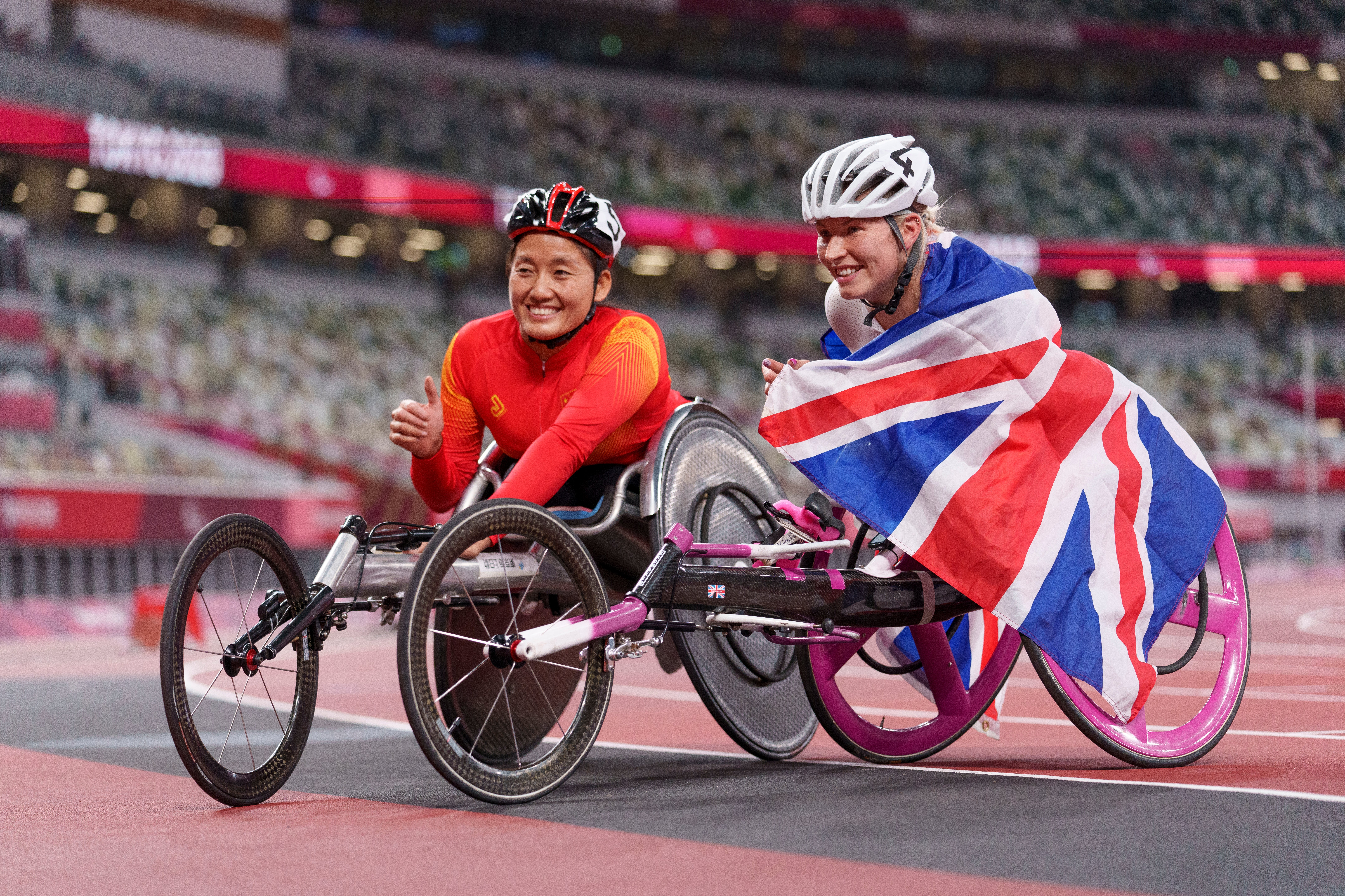 Second place finisher Hongzhuan Zhou of China poses with third place Samantha Kinghorn