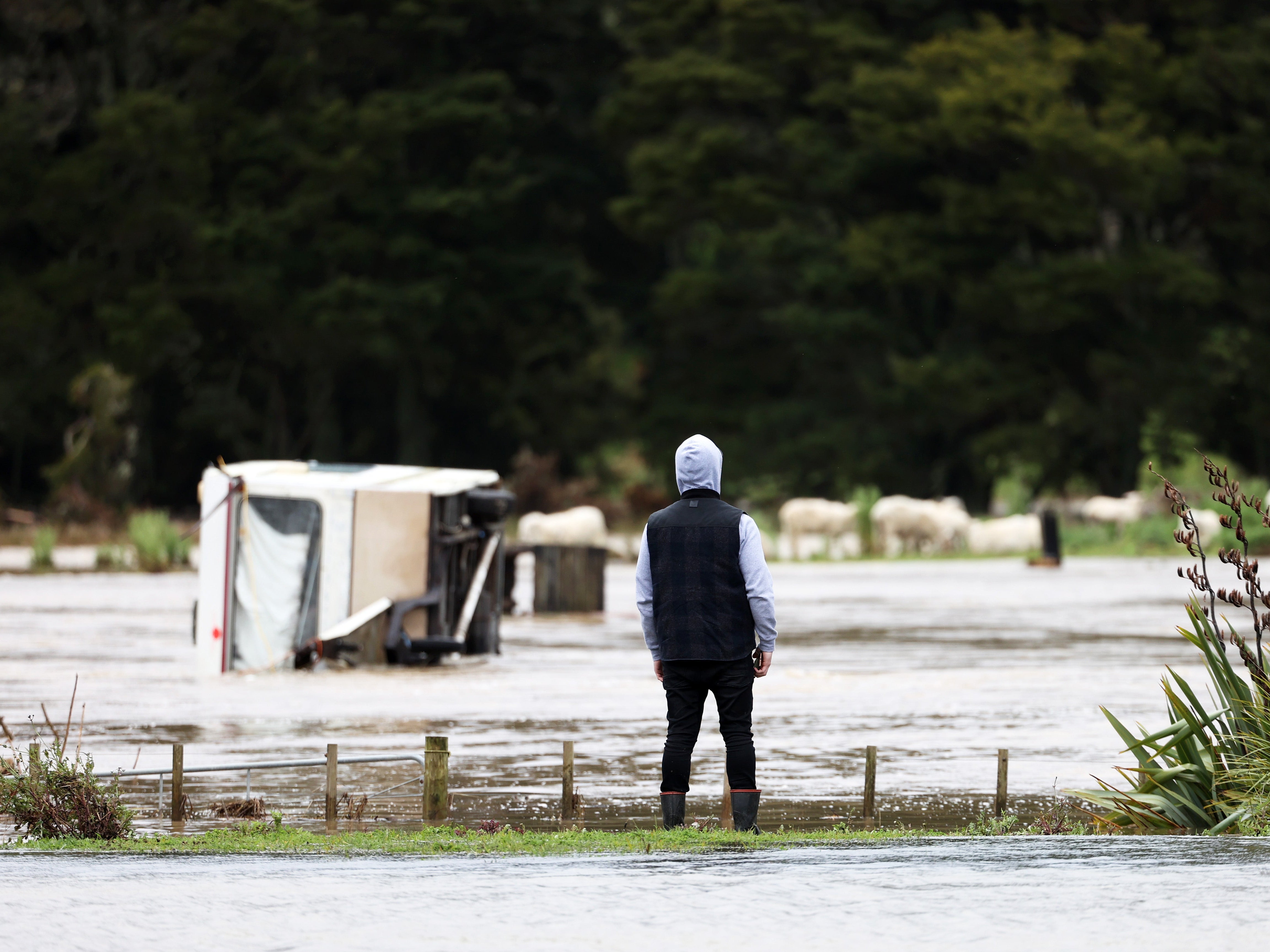 A vehicle submerged in flooding at Kumeu after heavy rain caused extensive flooding in Auckland, New Zealand
