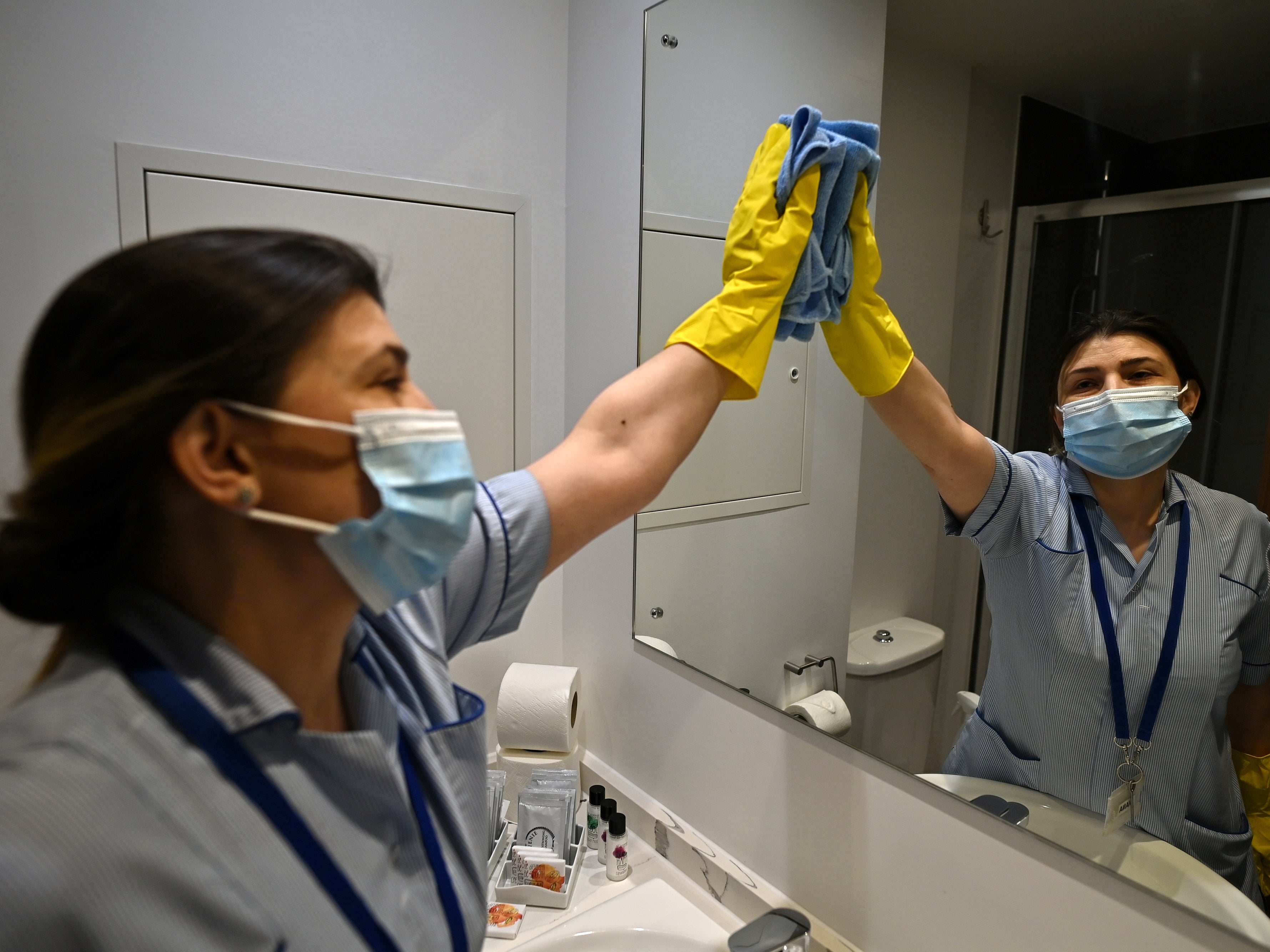 A staff member cleans surfaces at a hotel near Heathrow Airport