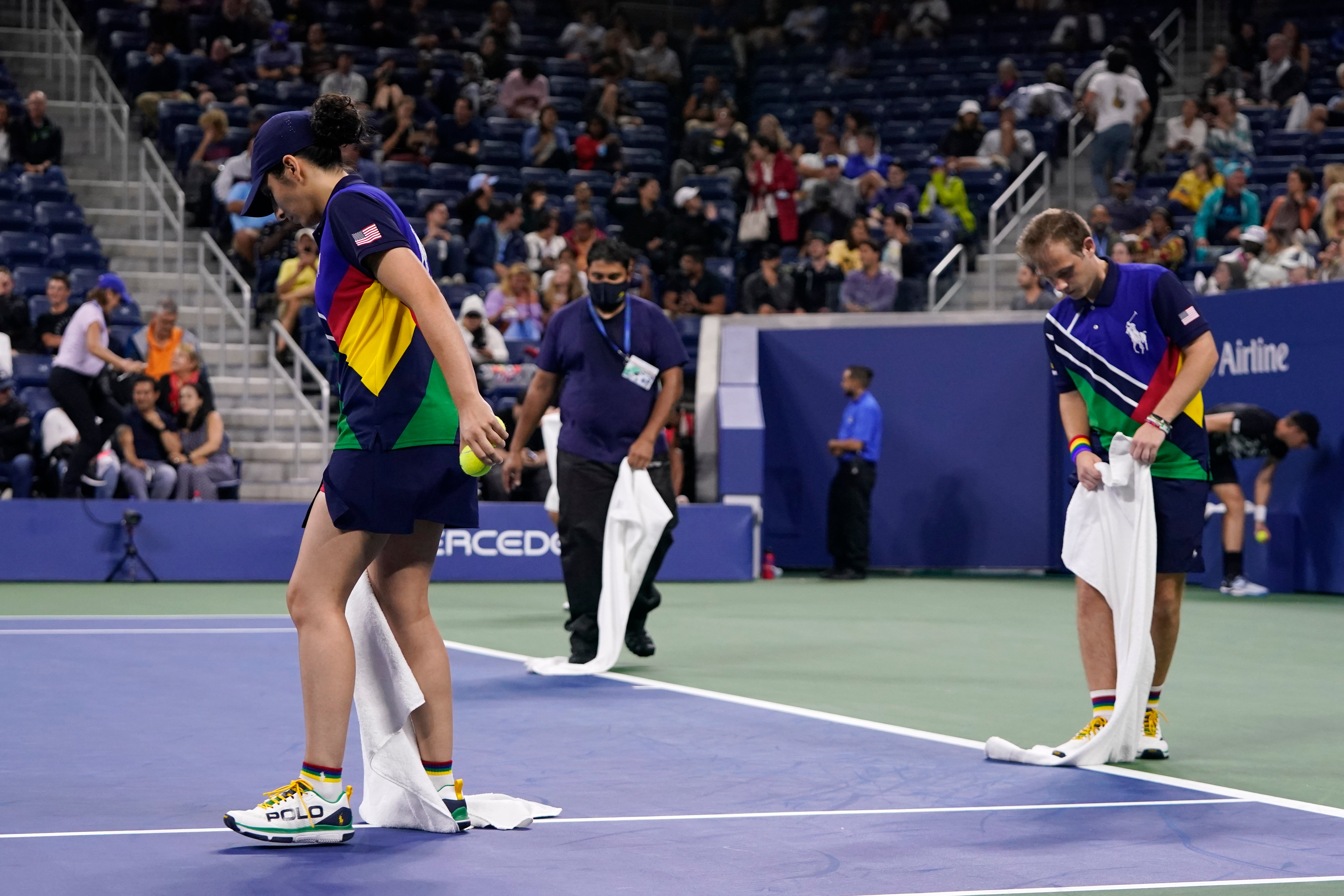 Stadium workers dry rain off the court in Louis Armstrong Stadium (Frank Franklin II/AP)