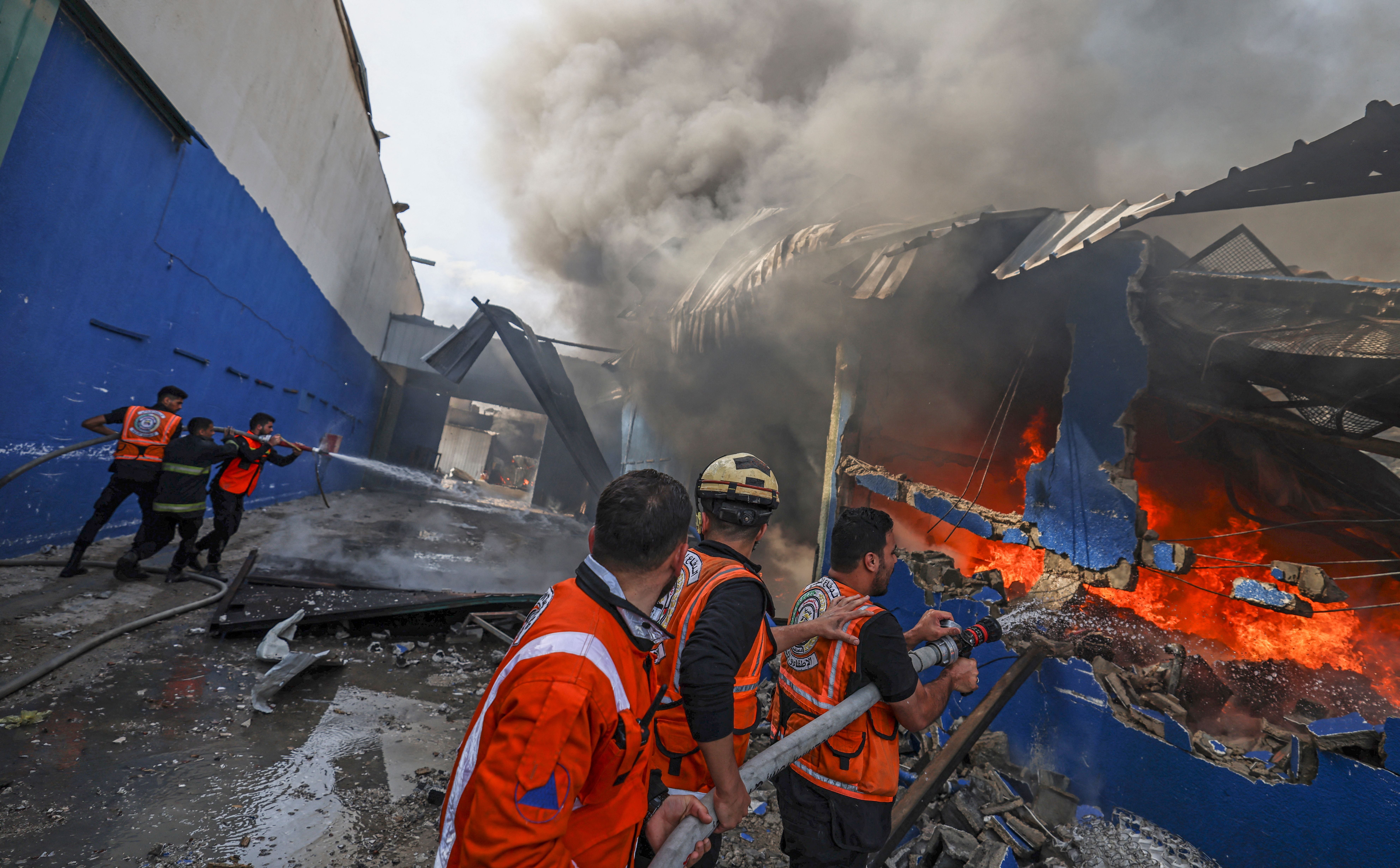 Palestinian firefighters douse a huge fire at the Foamco mattress factory east of Jabalia in the northern Gaza Strip