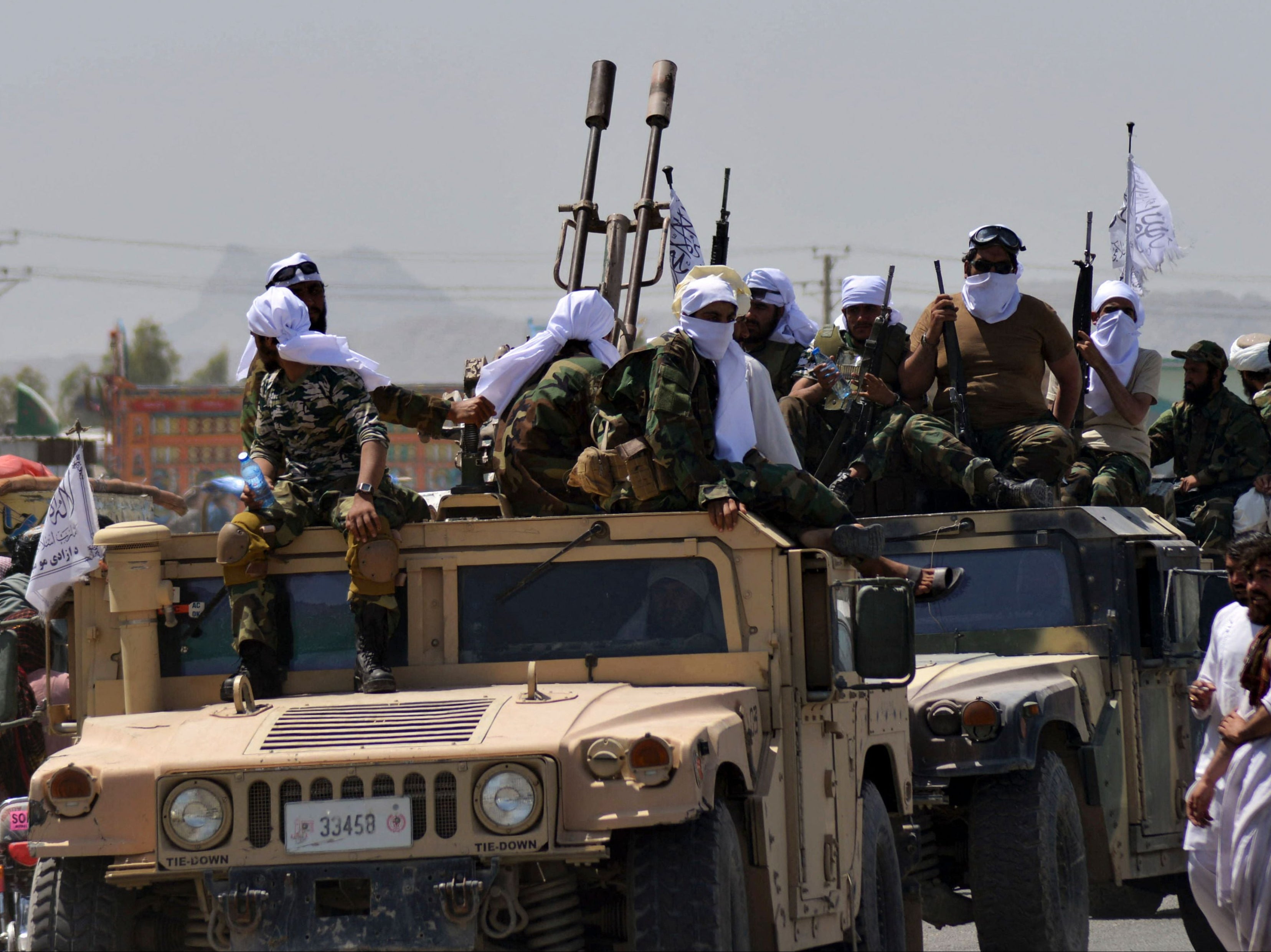 Taliban fighters atop Humvee vehicles parade along a road to celebrate after the US pulled all its troops out of Afghanistan, in Kandahar last week