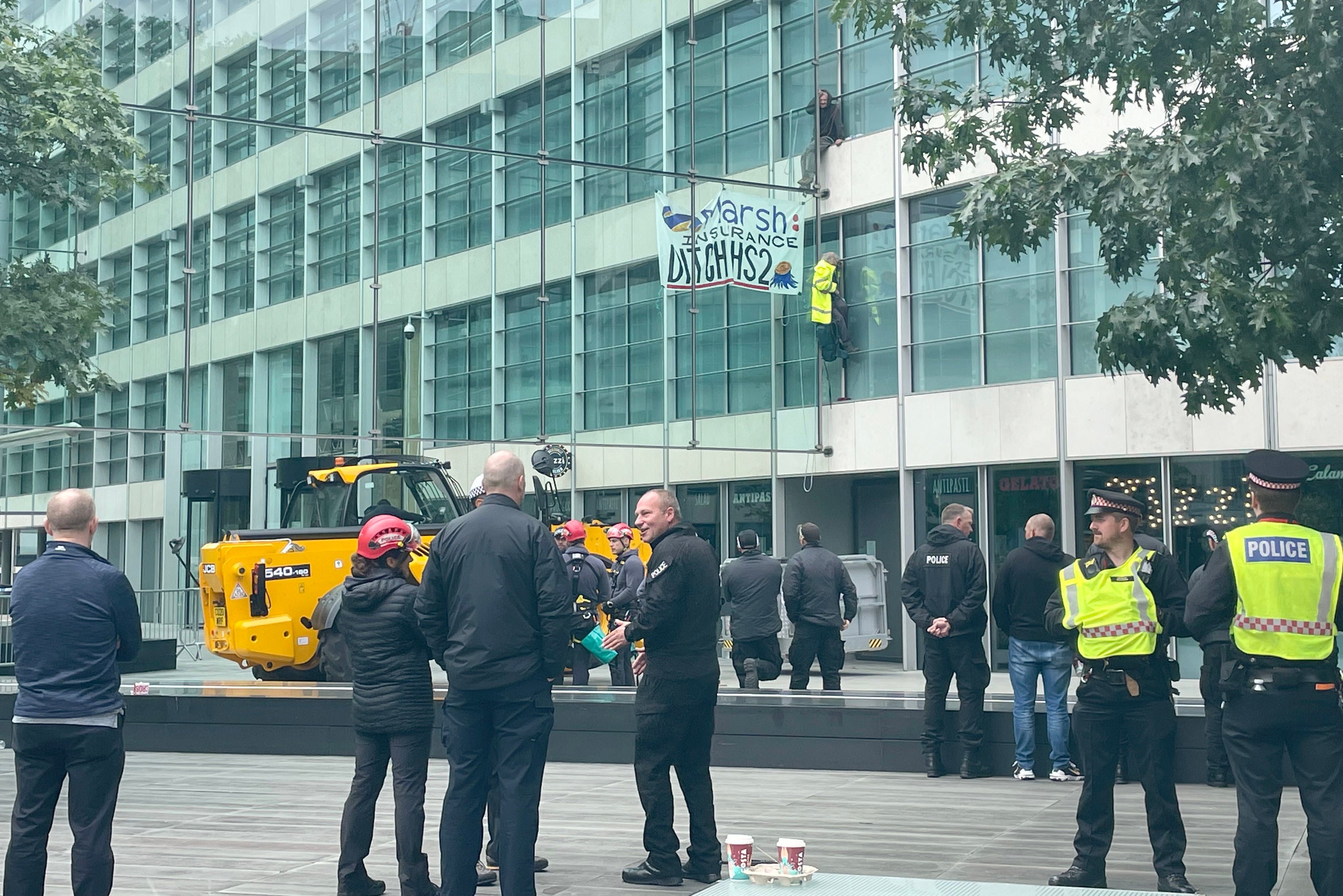 Protesters climbing the seven-storey offices of insurance company Marsh