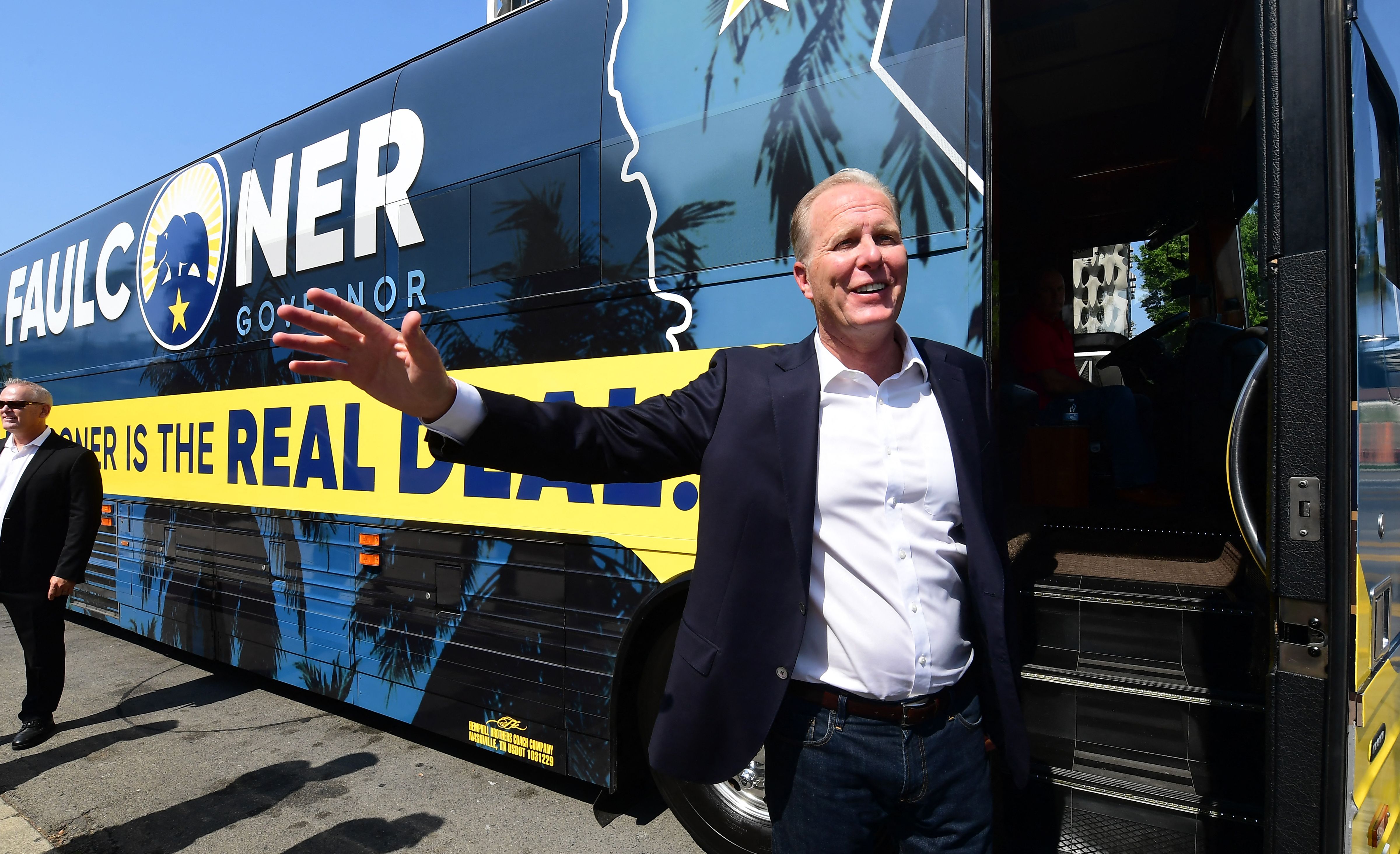 California Recall Election Republican candidate Kevin Faulconer waves while boarding his bus after stopping in Los Angeles, California, to promote his women's empowerment plan at a news conference on August 30, 2021. - The recall election for California Governor Gavin Newsom is on September 14th.