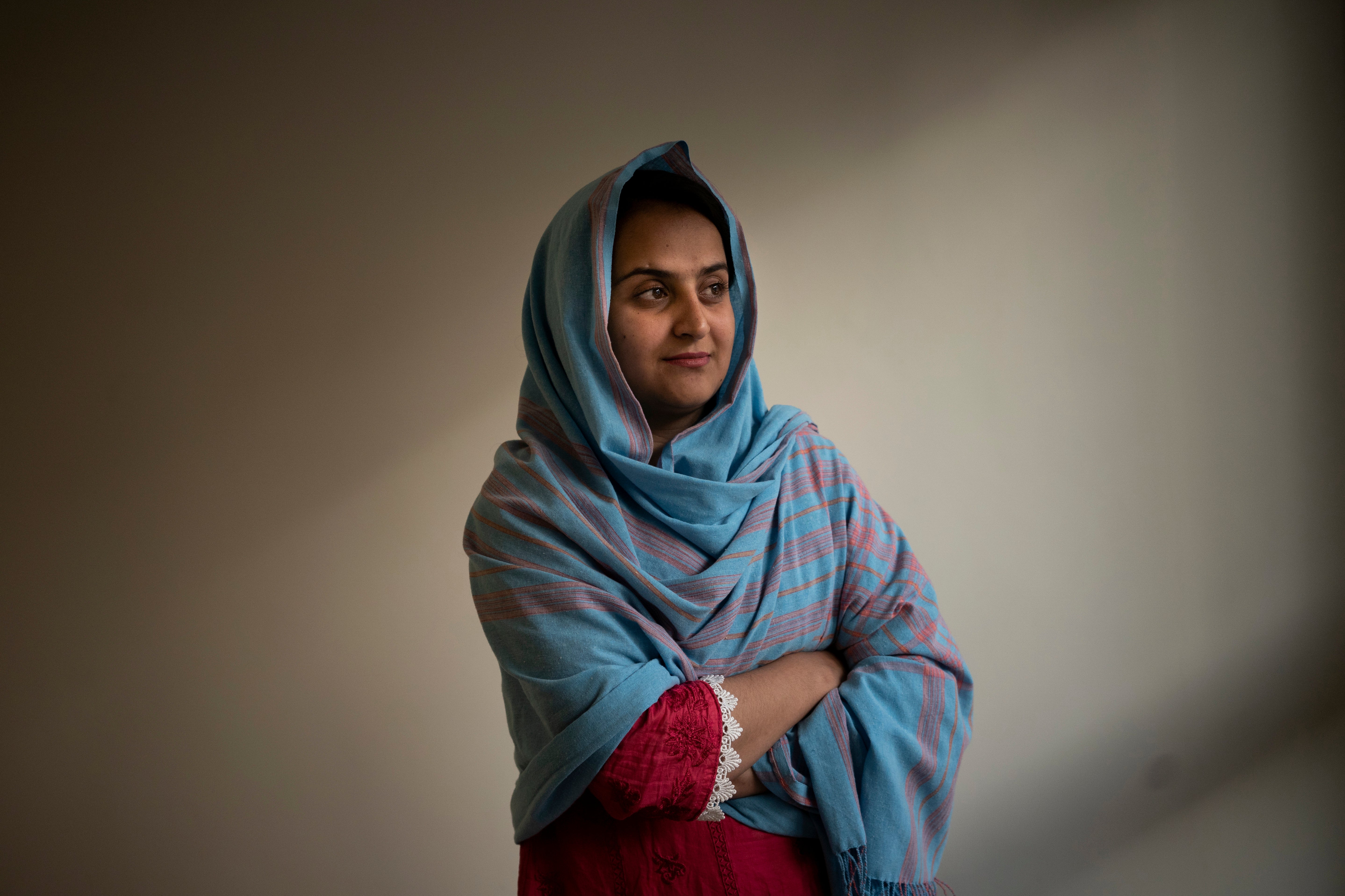 Behishta Arghand, a news anchor for the privately owned broadcaster Tolo News, poses for a photo inside a compound in Doha, Qatar