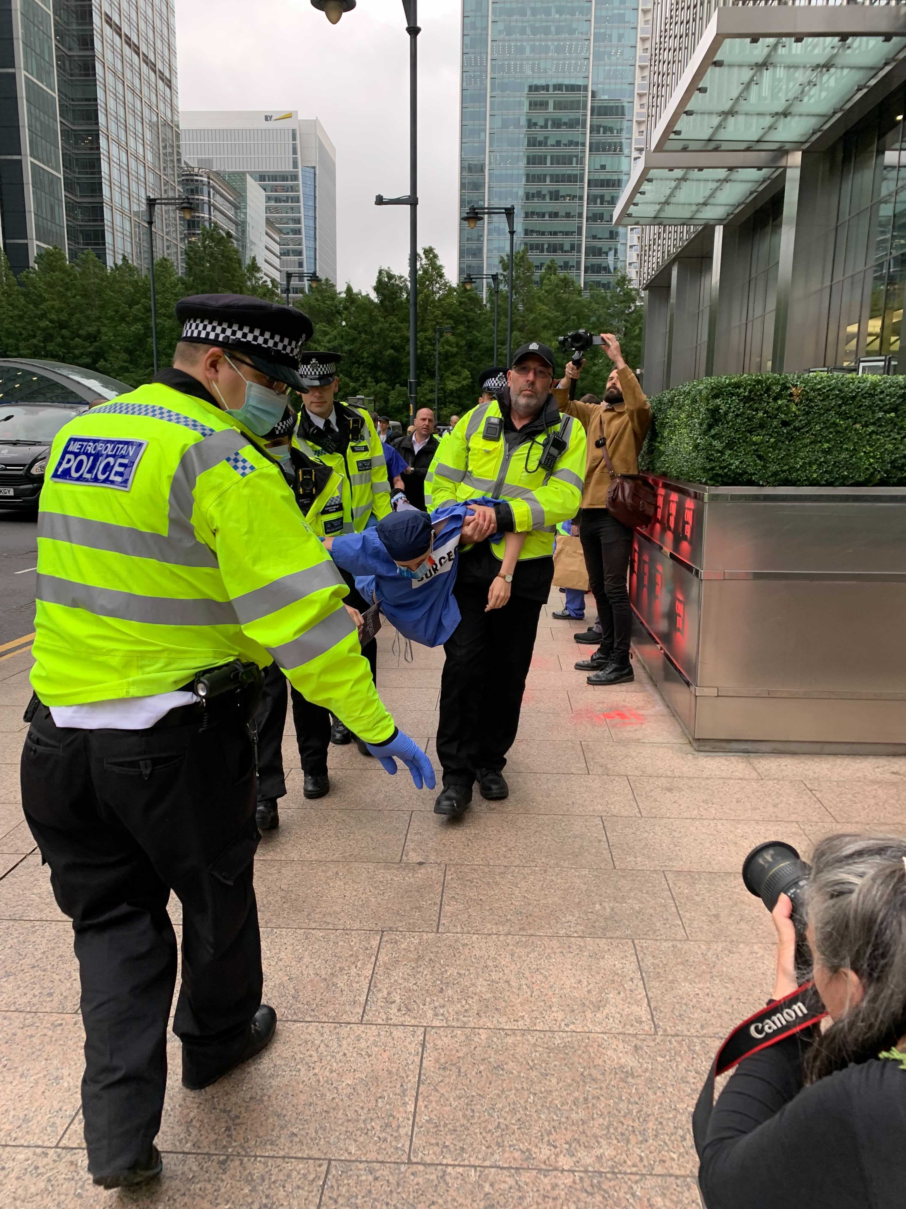 Police carry a protester away