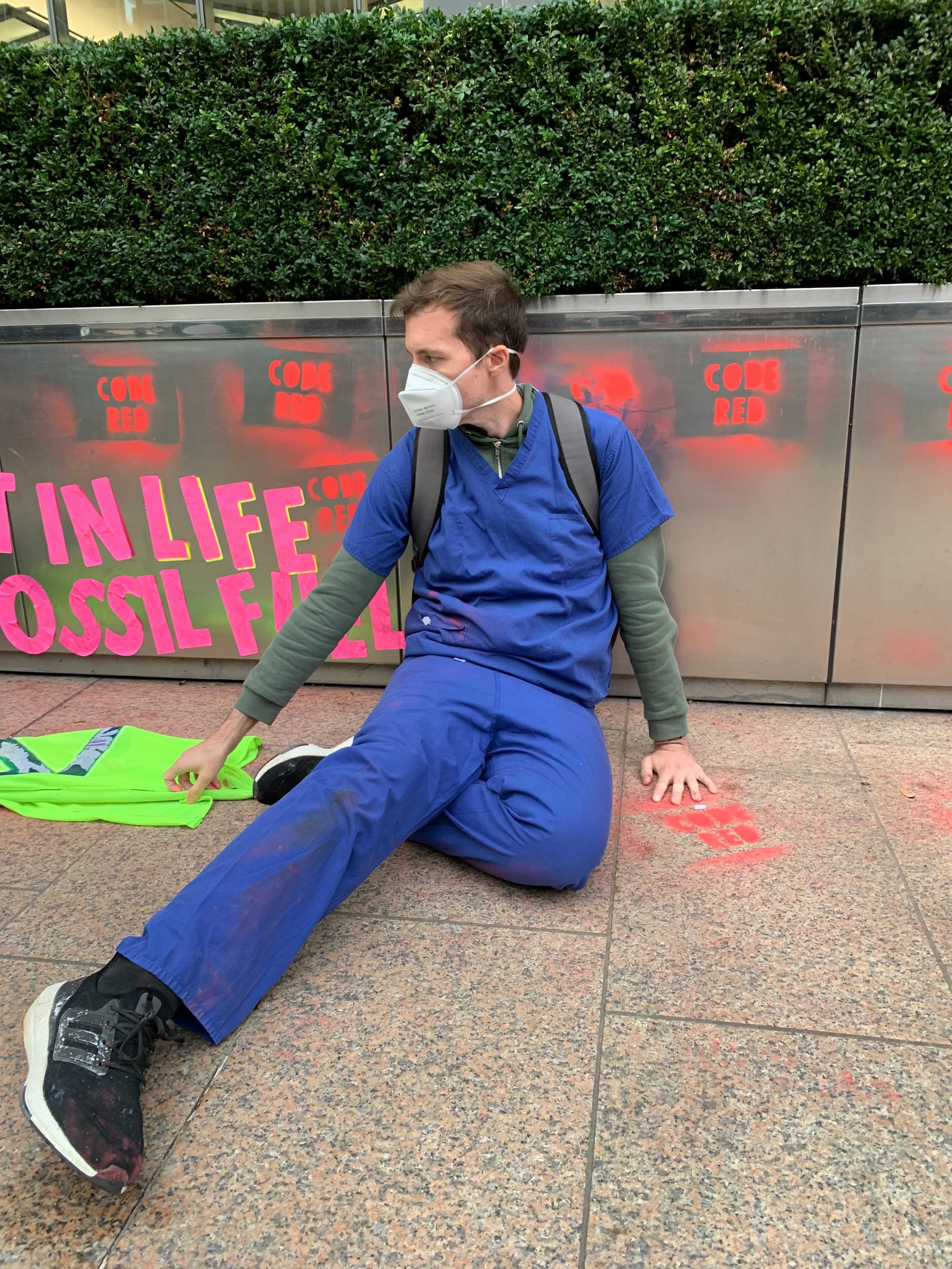 Protesters glued their hands to the floor or to flower boxes