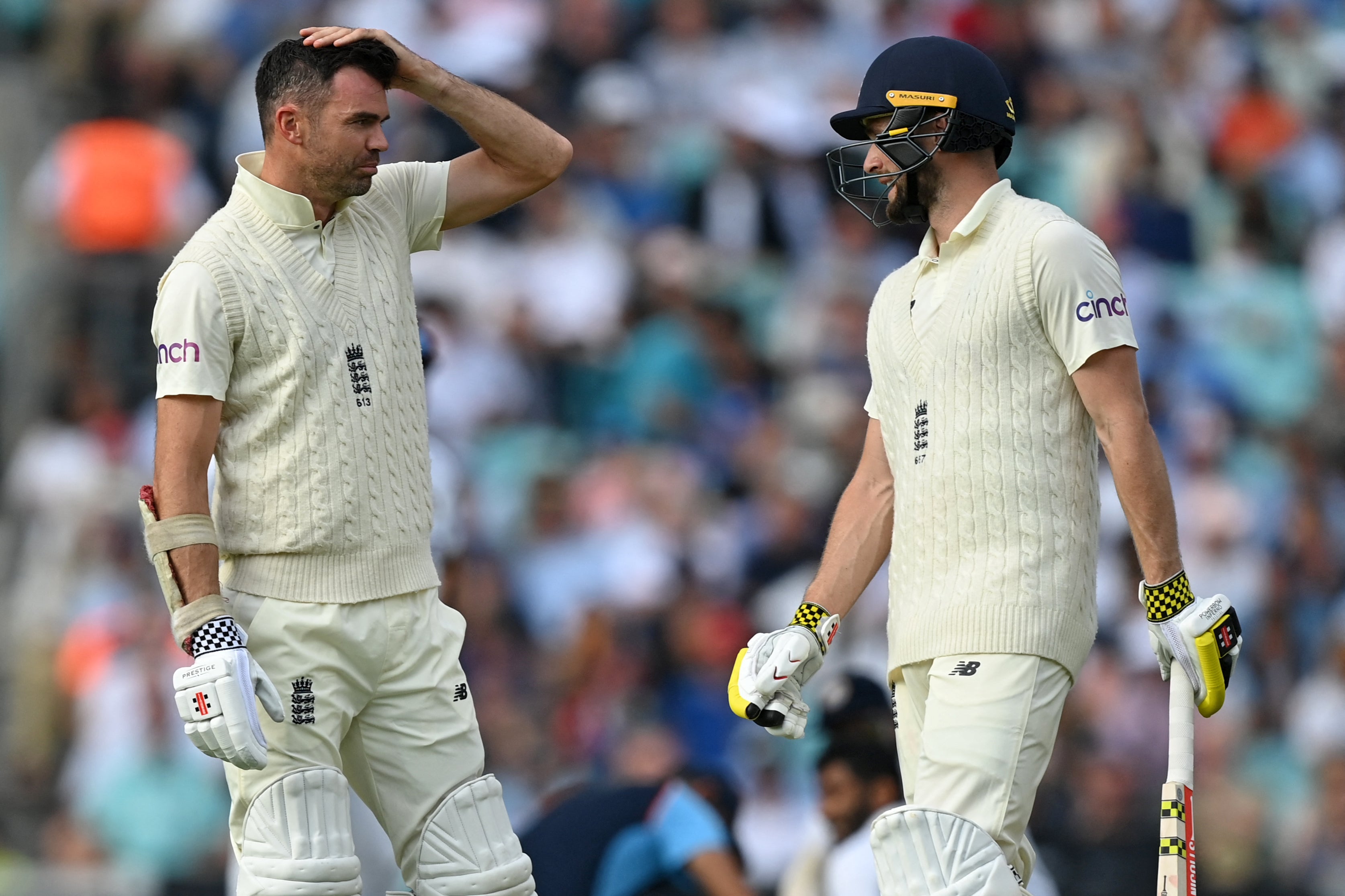 James Anderson (left) talks to Chris Woakes during their last-wicket stand