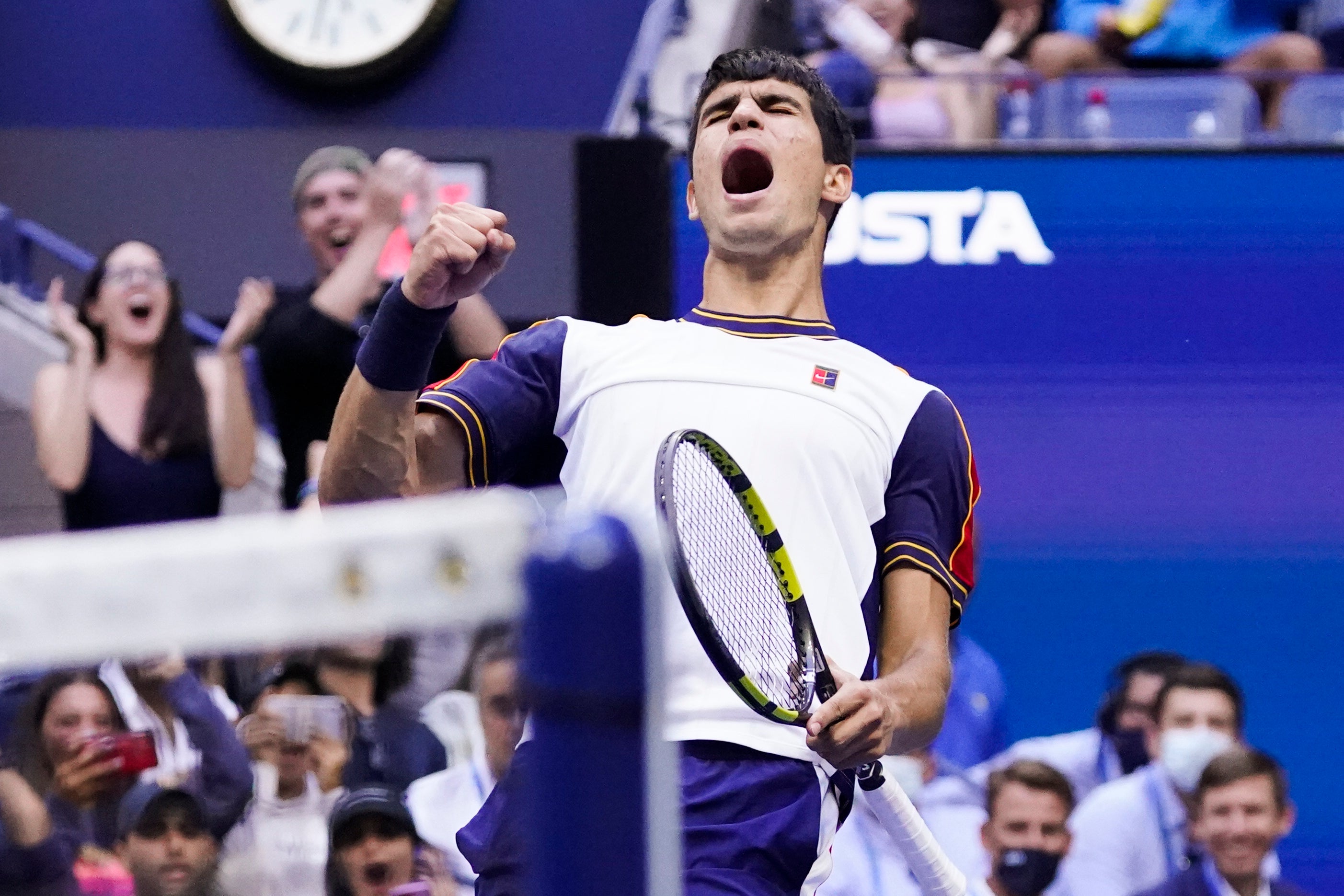 Carlos Alcaraz celebrates winning a point against Stefanos Tsitsipas (Seth Wenig/AP)