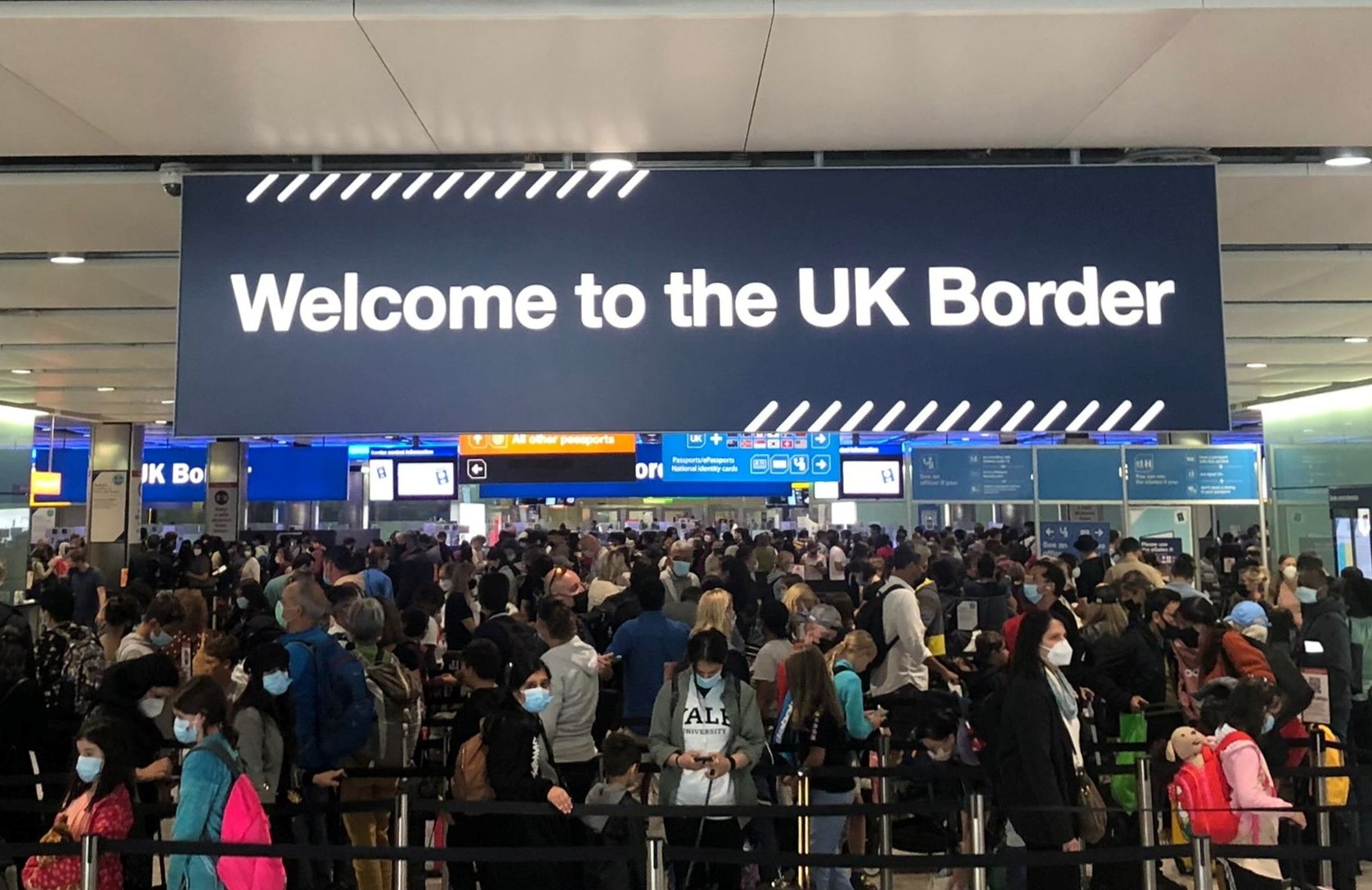 Queues of people wait in line at Heathrow Airport in London on 1 September 2021