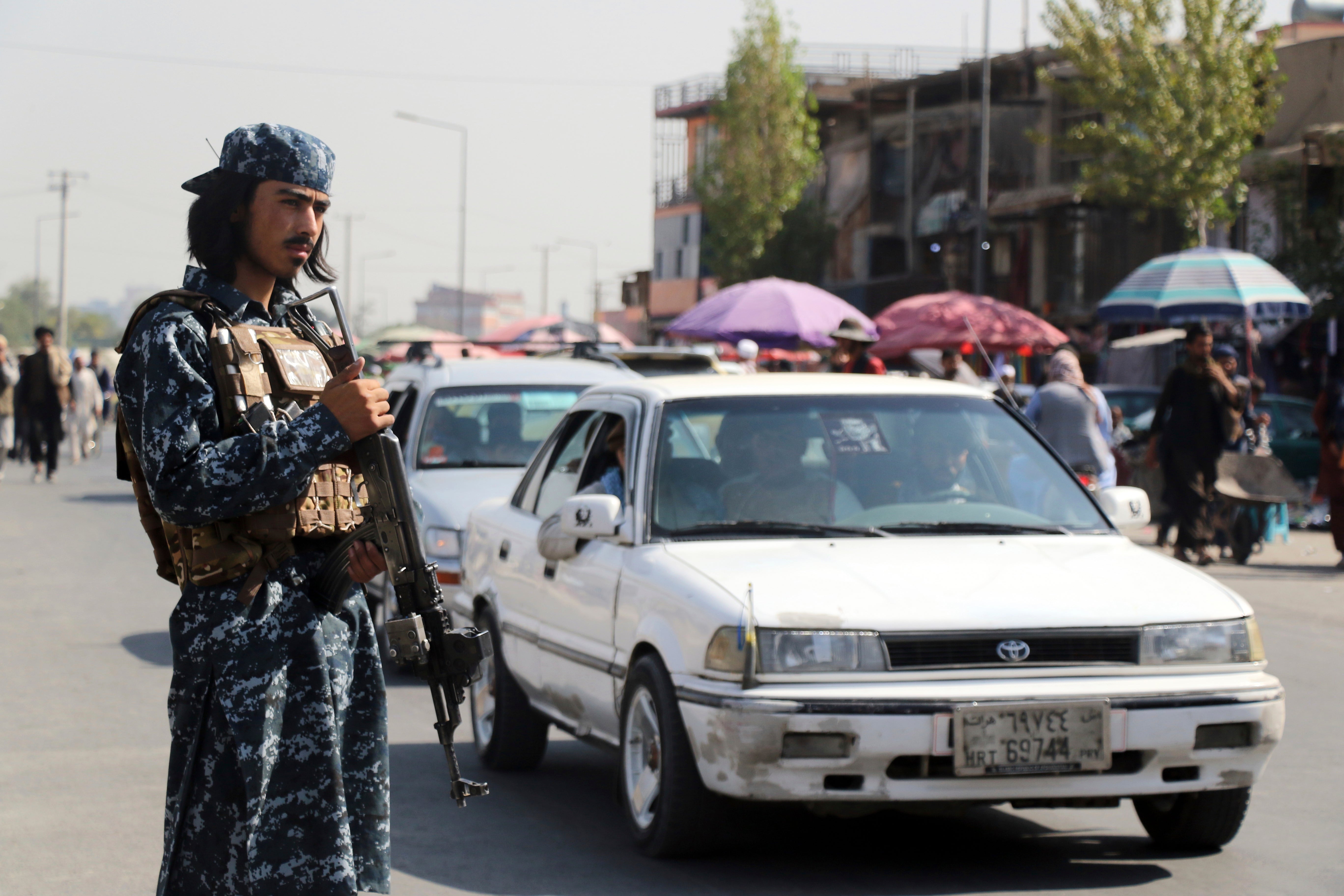 Taliban fighter stands guard in the city of Kabul, Afghanistan. The militant group has released rules for women attending universities