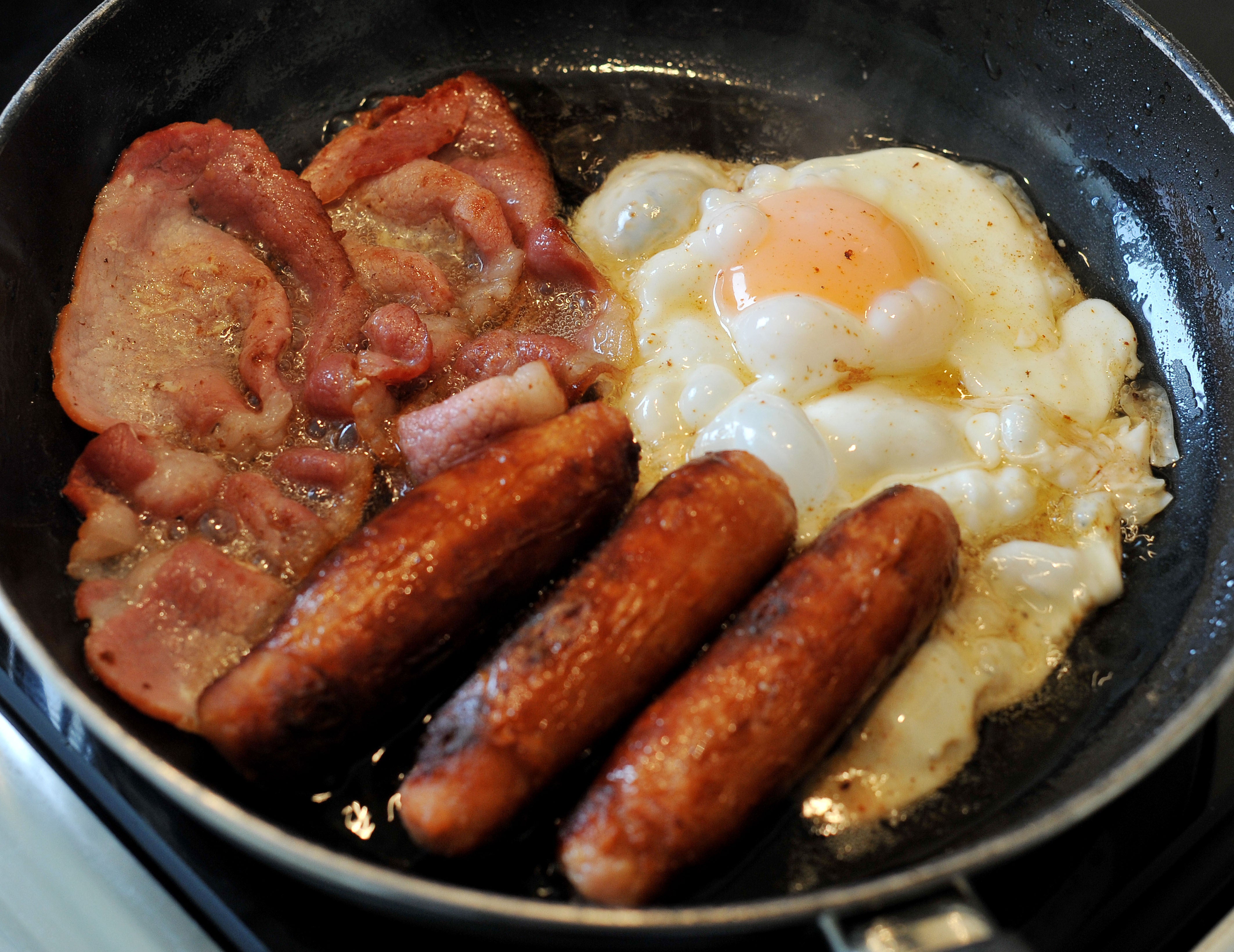 Egg, sausages and bacon being fried in a frying pan (Nick Ansell/PA)