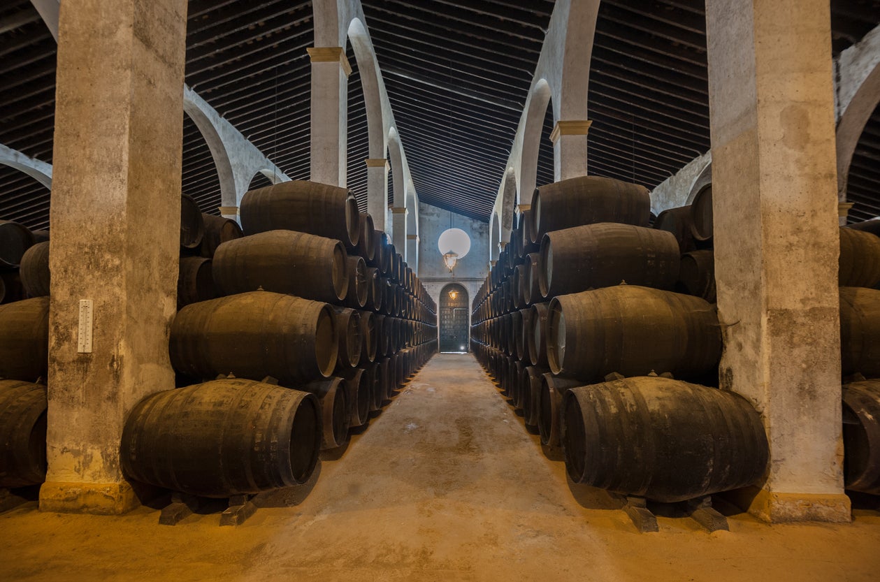 Sherry barrels line a walkway in a bodega in Jerez, Spain