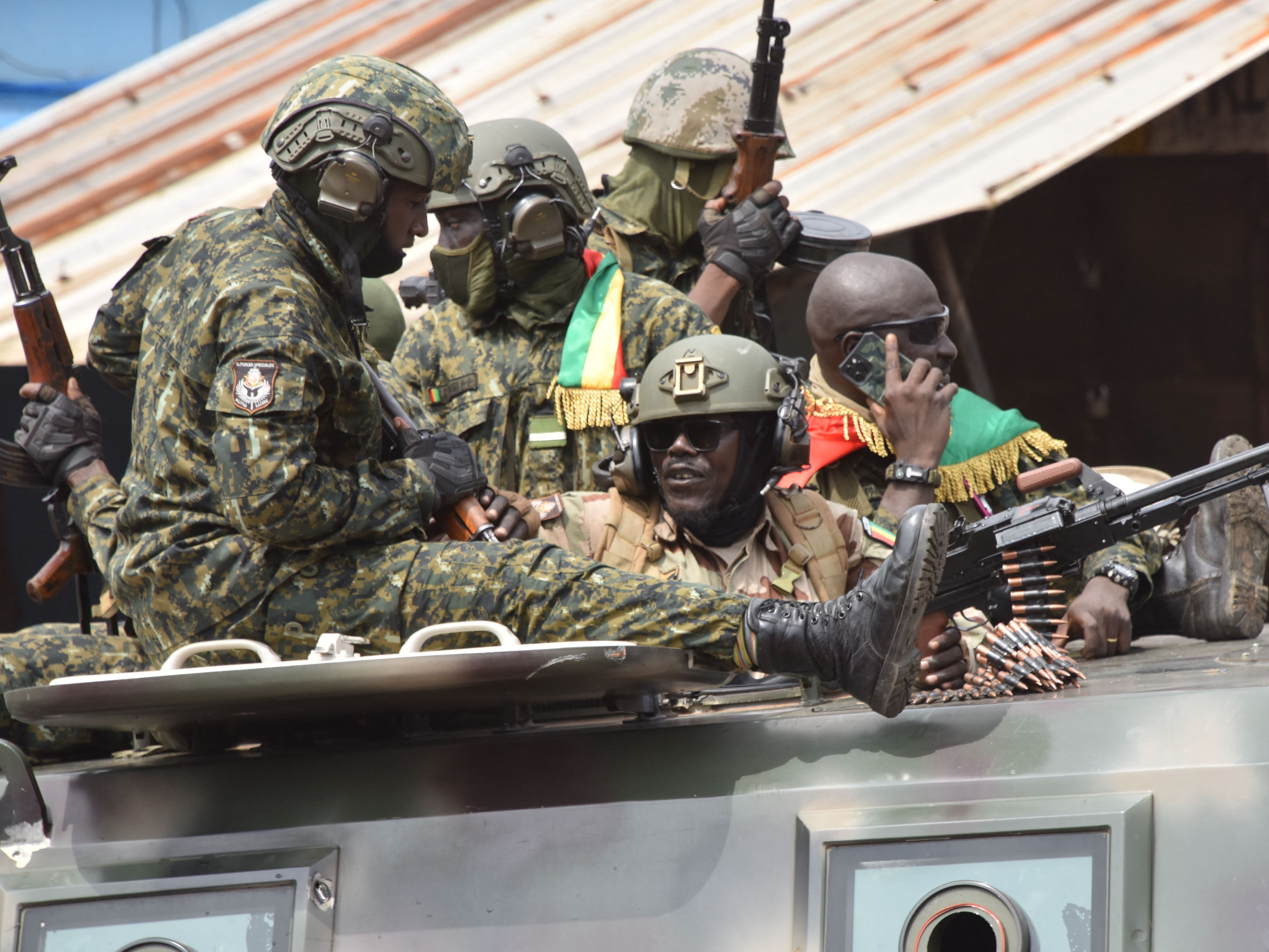 Members of the Guinean military celebrate the arrest of the former president Alpha Conde on Sunday