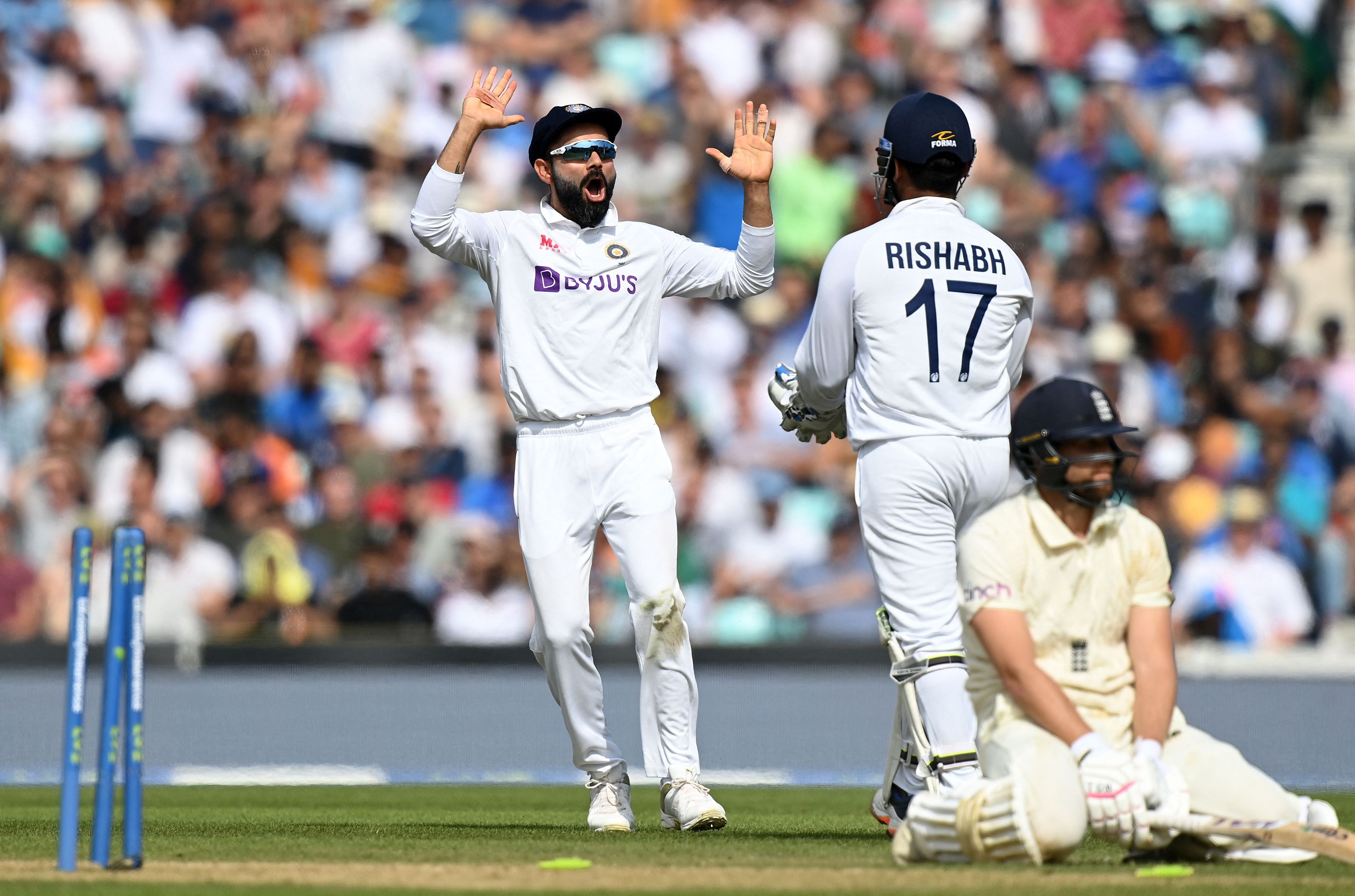 Virat Kohli celebrates the run out of Dawid Malan