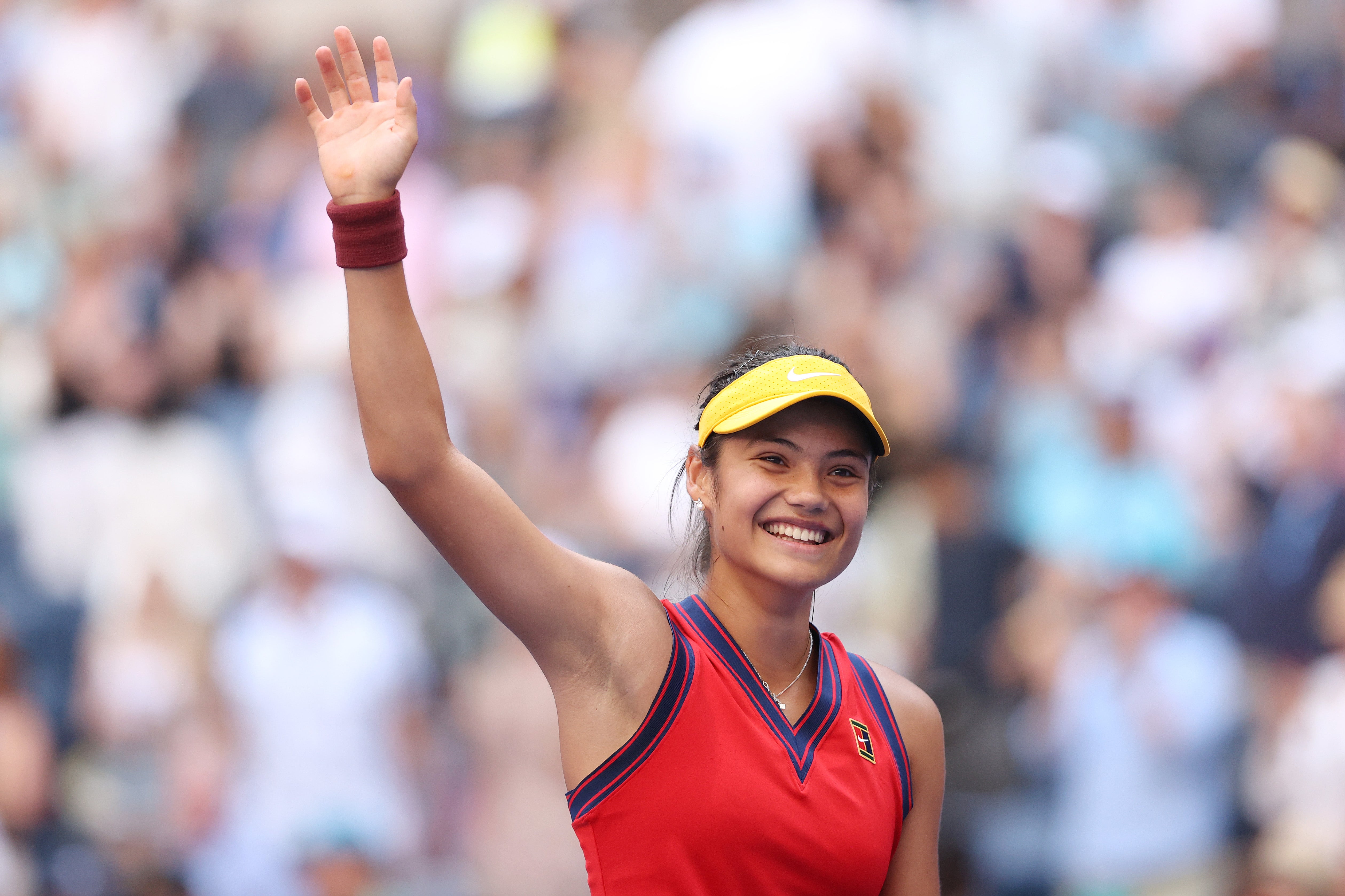 Emma Raducanu salutes the crowd after securing victory