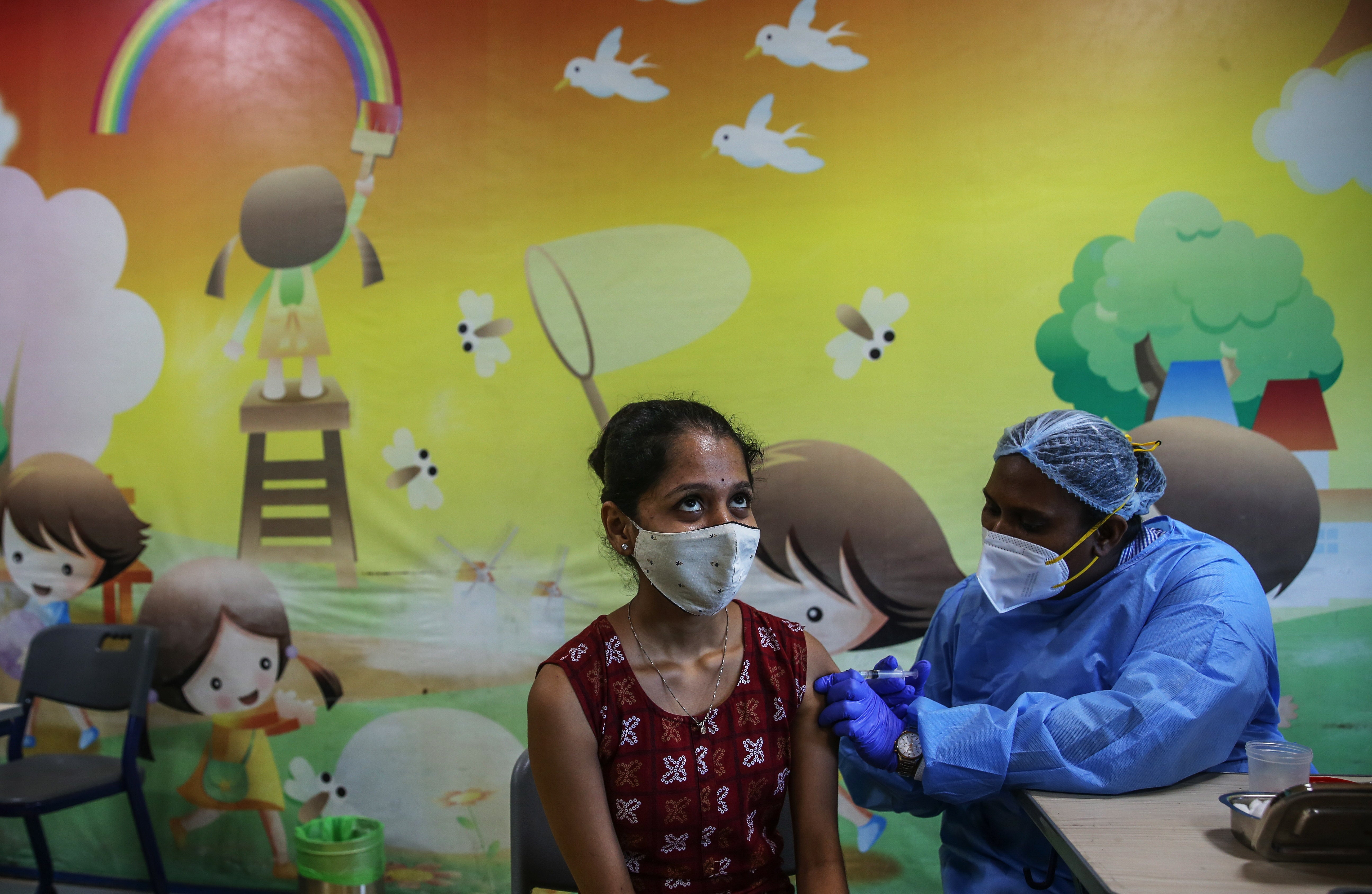 File: A woman receives a shot of vaccine against Covid-19 during a mass vaccination drive, in Mumbai, India on 2 September 2021