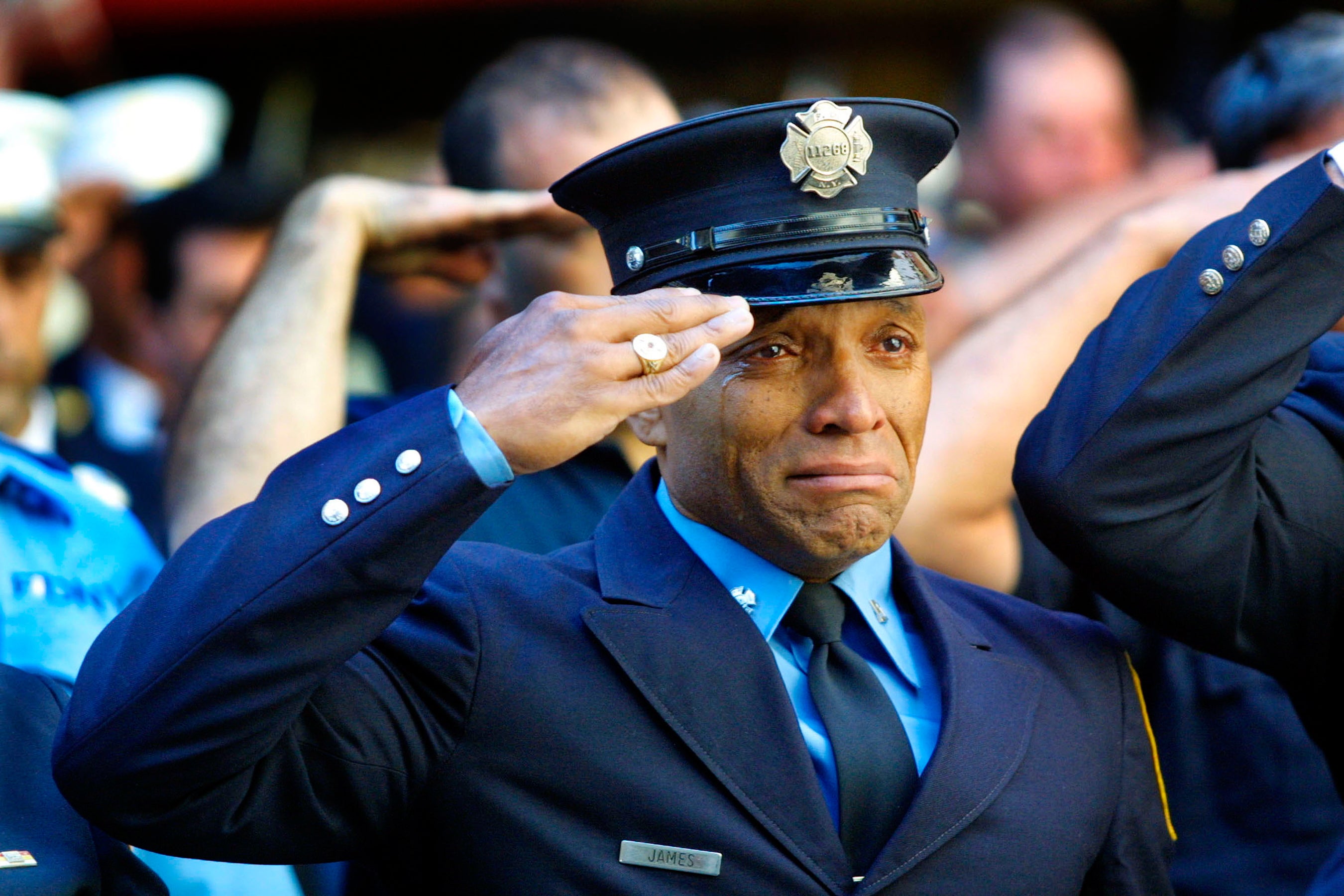 Firefighter Tony James cries while attending the funeral service for New York Fire Department Chaplain Rev Mychal Judge, in front of the St Francis of Assisi Church on 15 September, 2001. Judge died while giving the last rites to a fireman in the collapse of the World Trade Centre