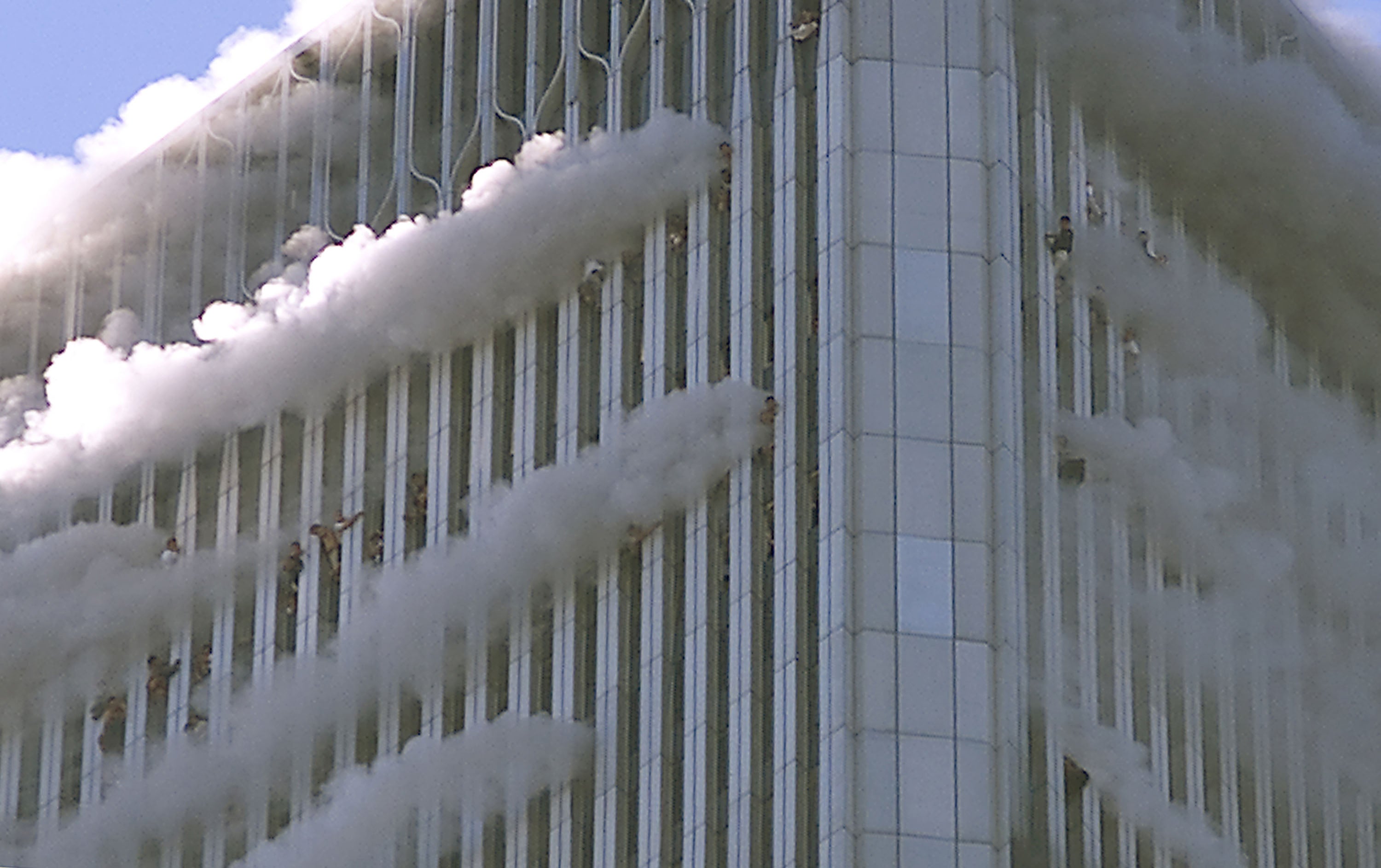 People hang from the windows of the North Tower