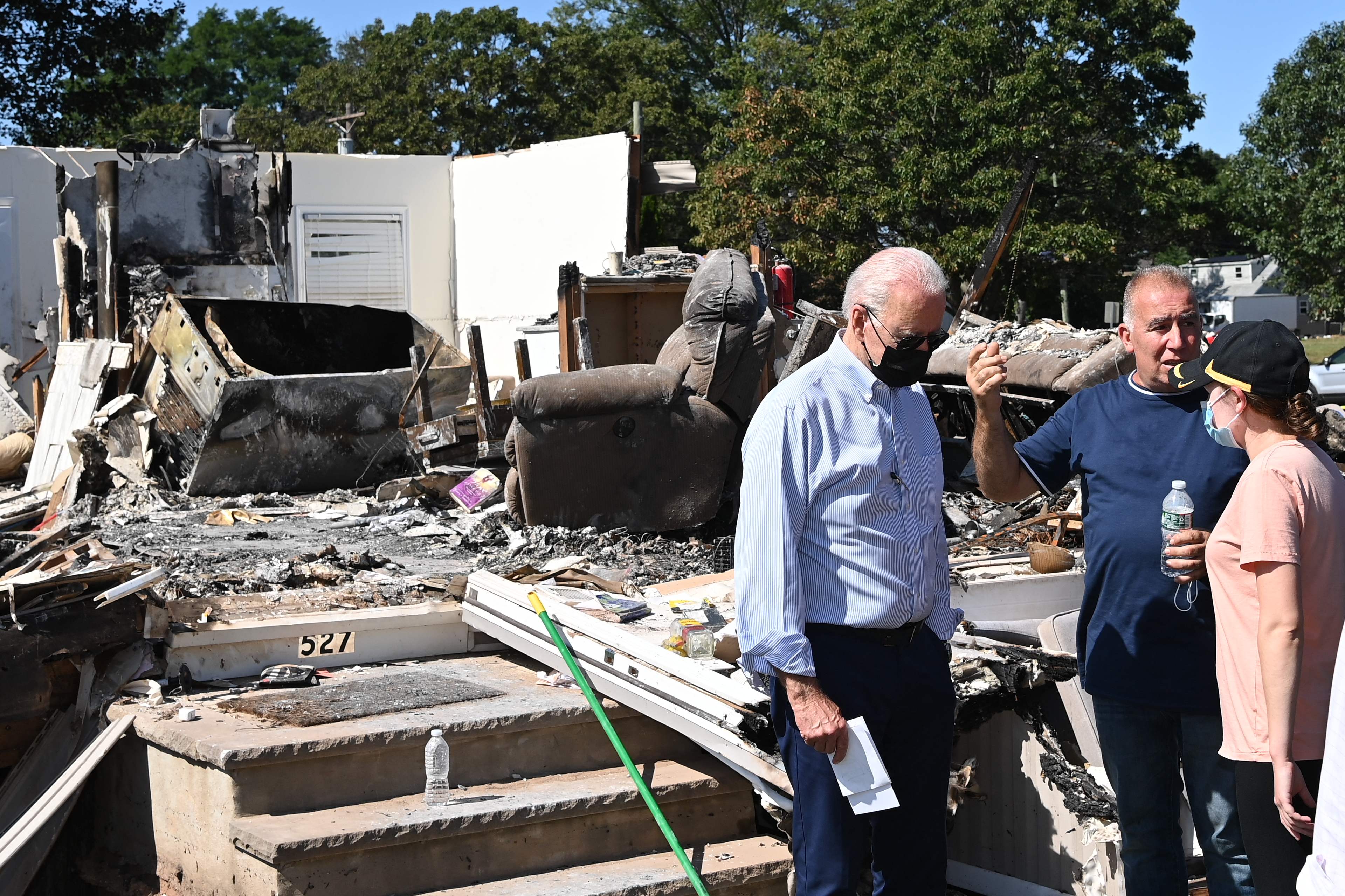 Joe Biden tours a neighbourhood in New Jersey on 7 September impacted by the remants of Hurricane Ida.