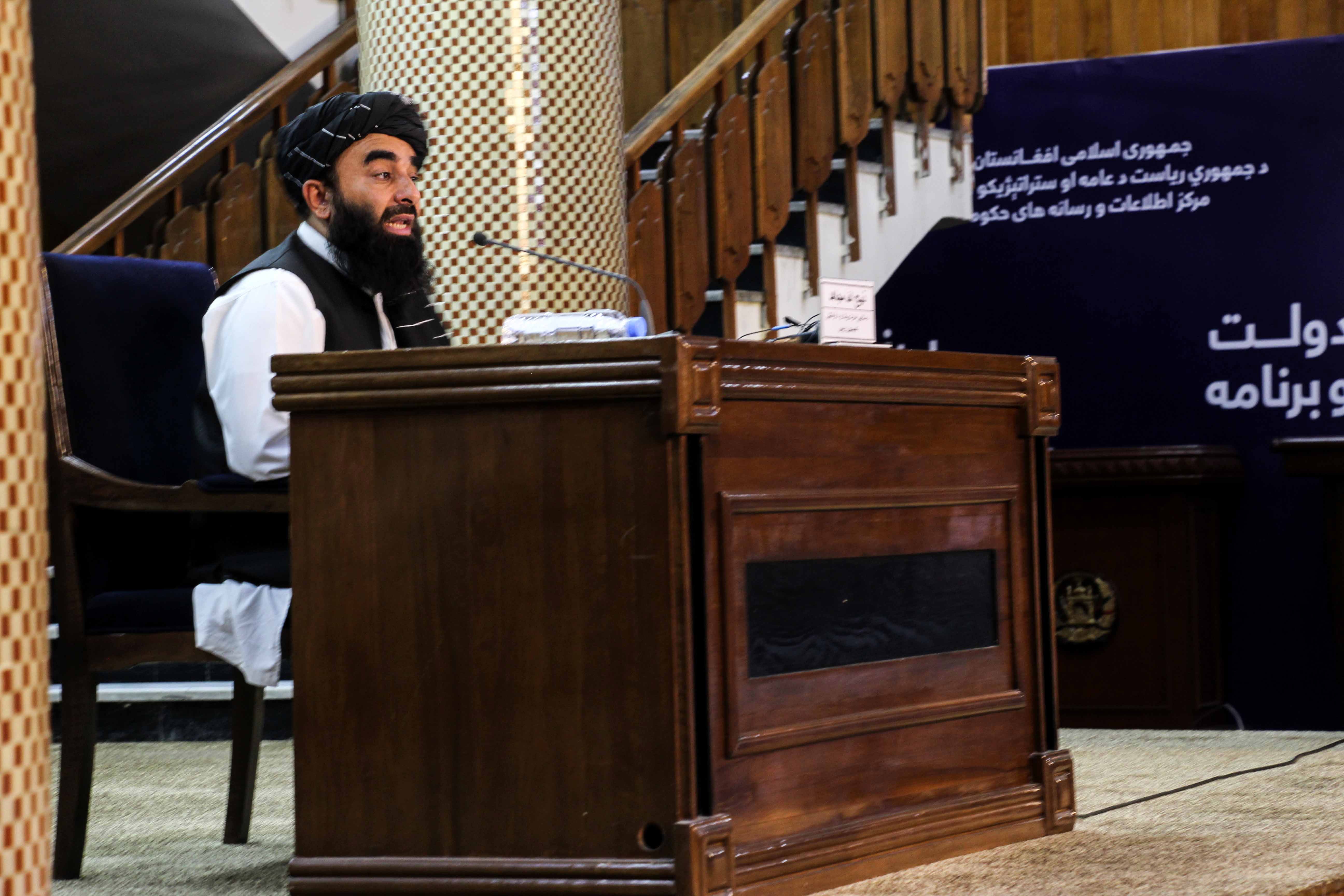 Zabhiullah Mujahid, the Taliban spokesperson, talks with journalists as he announces the interim government