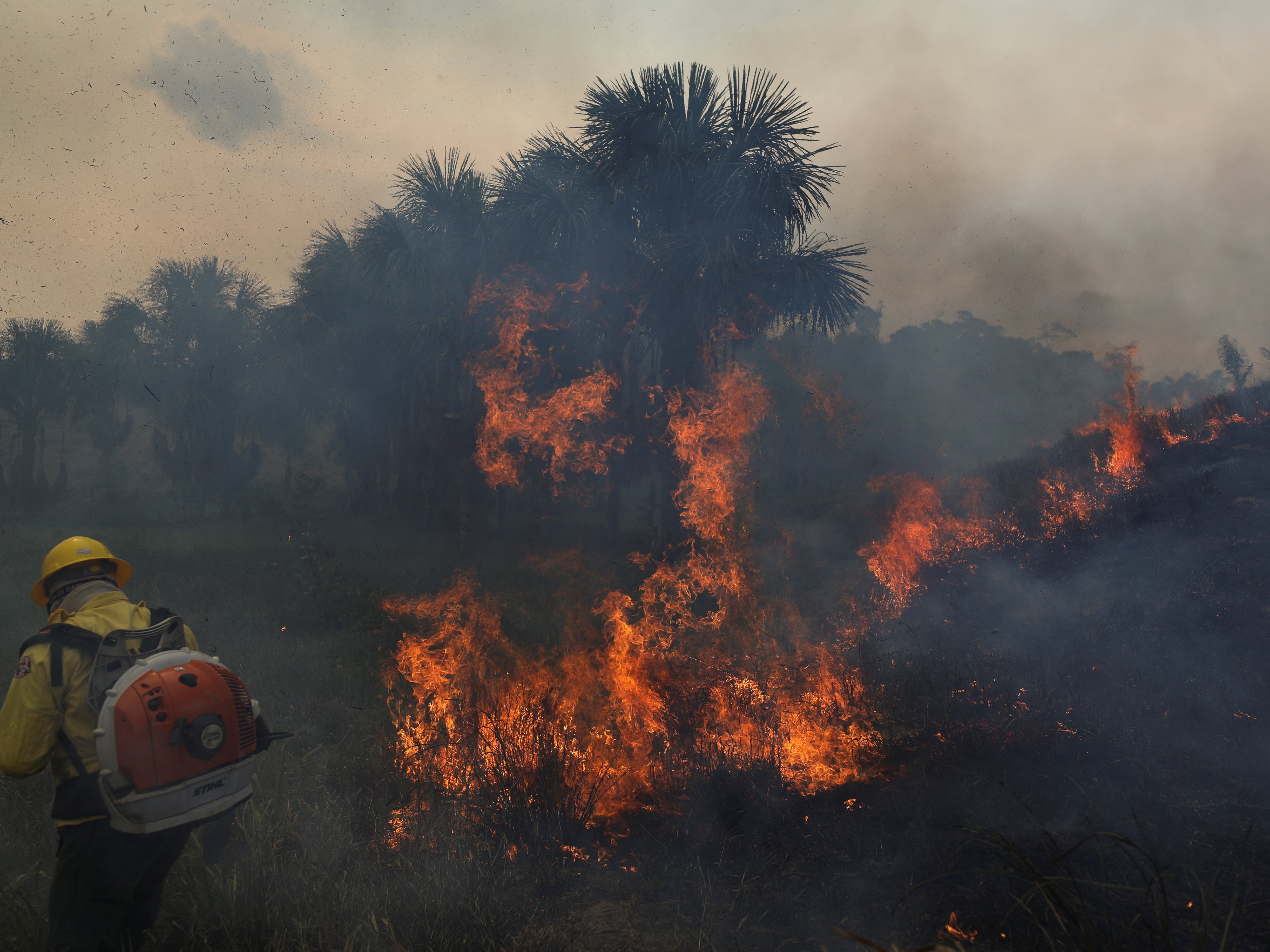 Fire crews attempting to tackle a fire in Apui, Amazonas state, Brazil, on 5 September