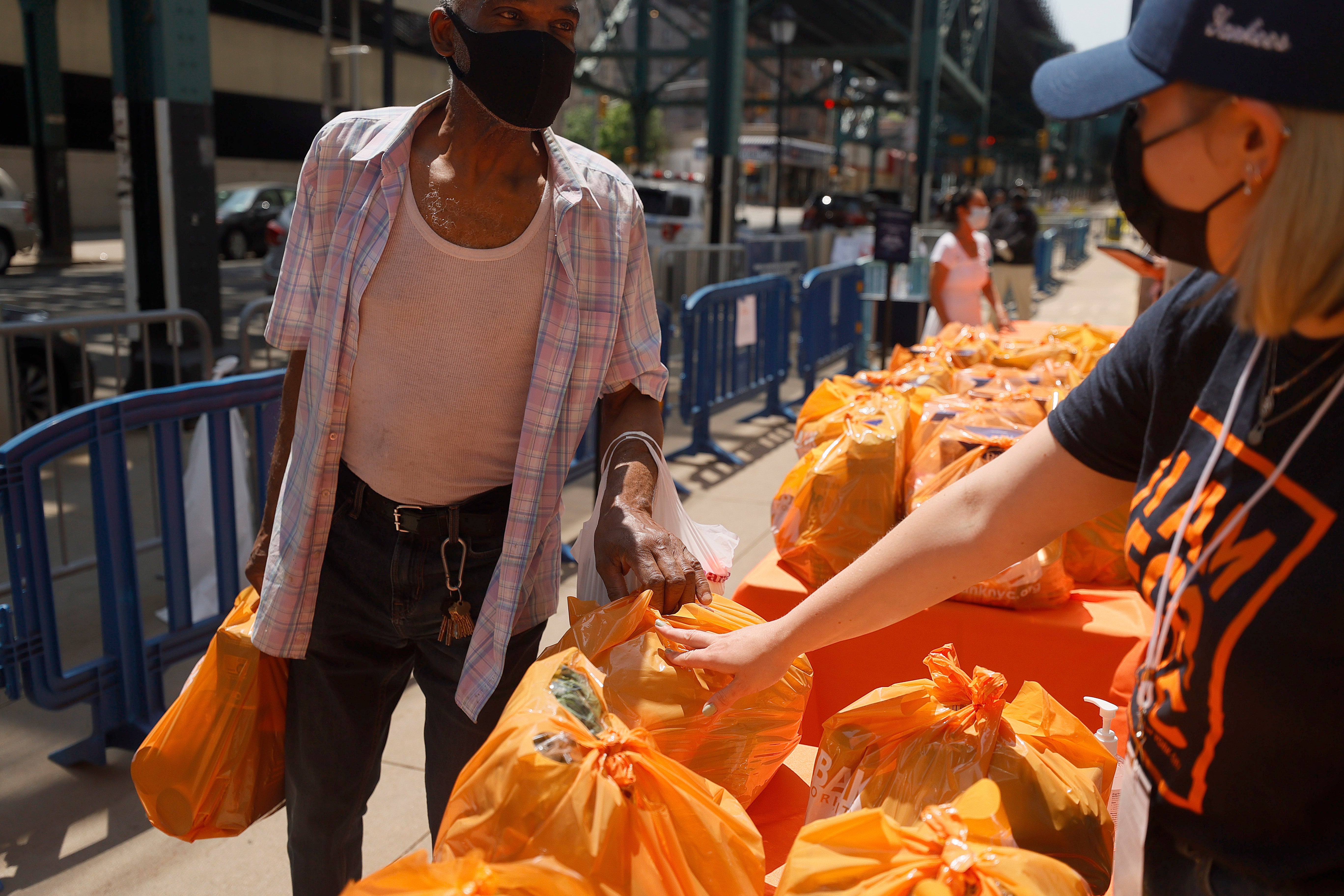 Local residents receive food items as Food Bank For New York City teams up with the New York Yankees to kick-off monthly food distribution for New Yorkers in need at Yankee Stadium on May 20, 2021 in New York City.