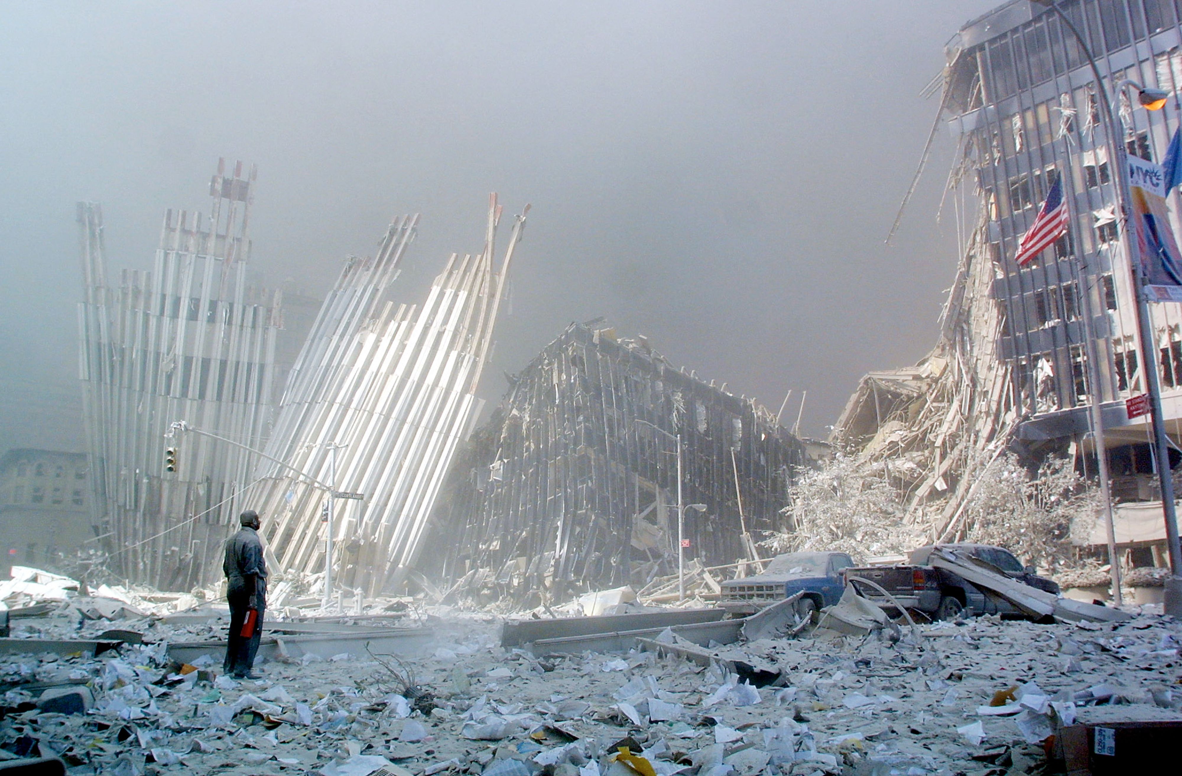 A man stands in the rubble and calls out asking if anyone needs help on 9/11