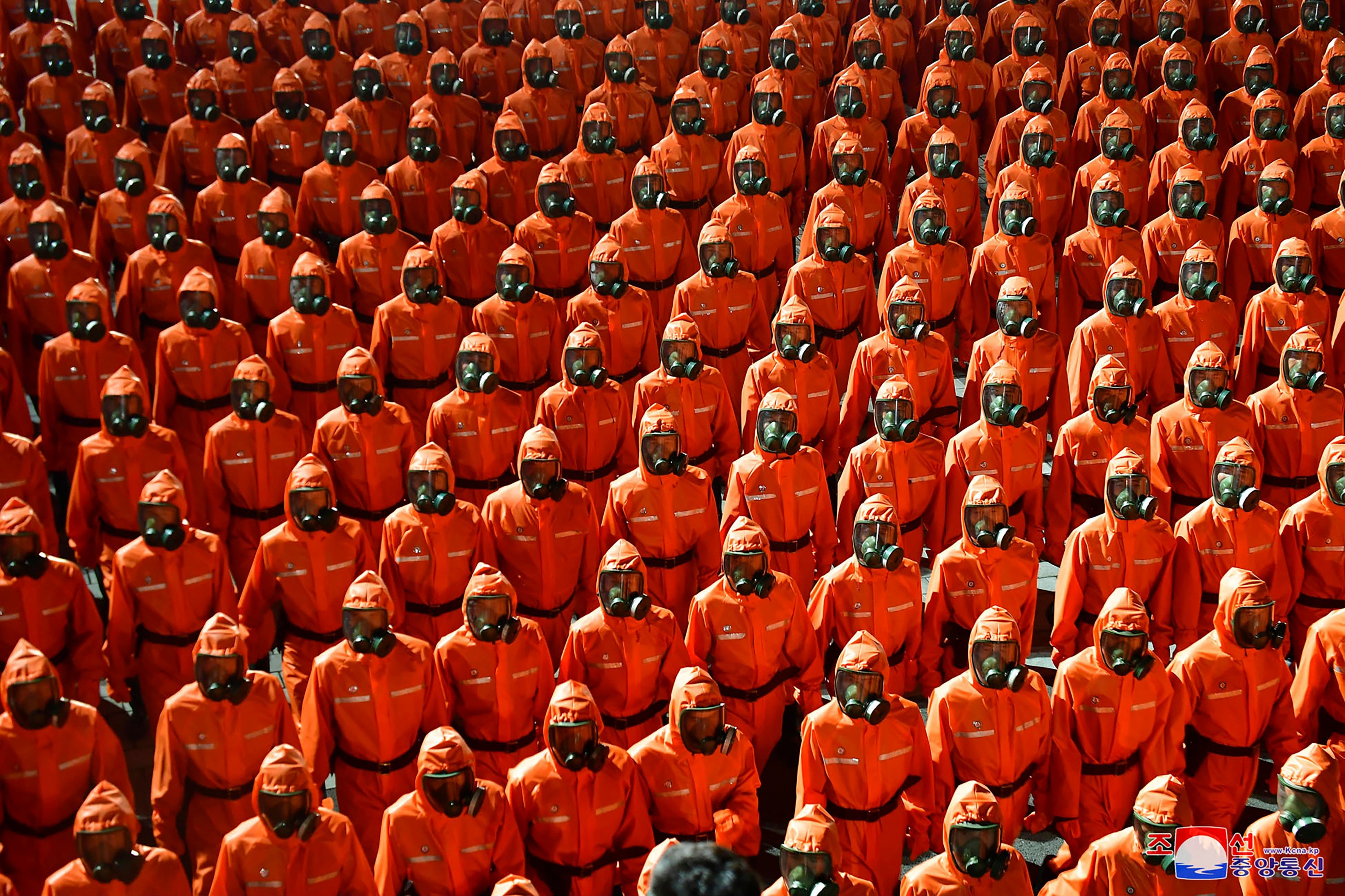 North Korean troops wearing gas masks and bright red suits parade during a celebration of the nation’s 73rd anniversary this week