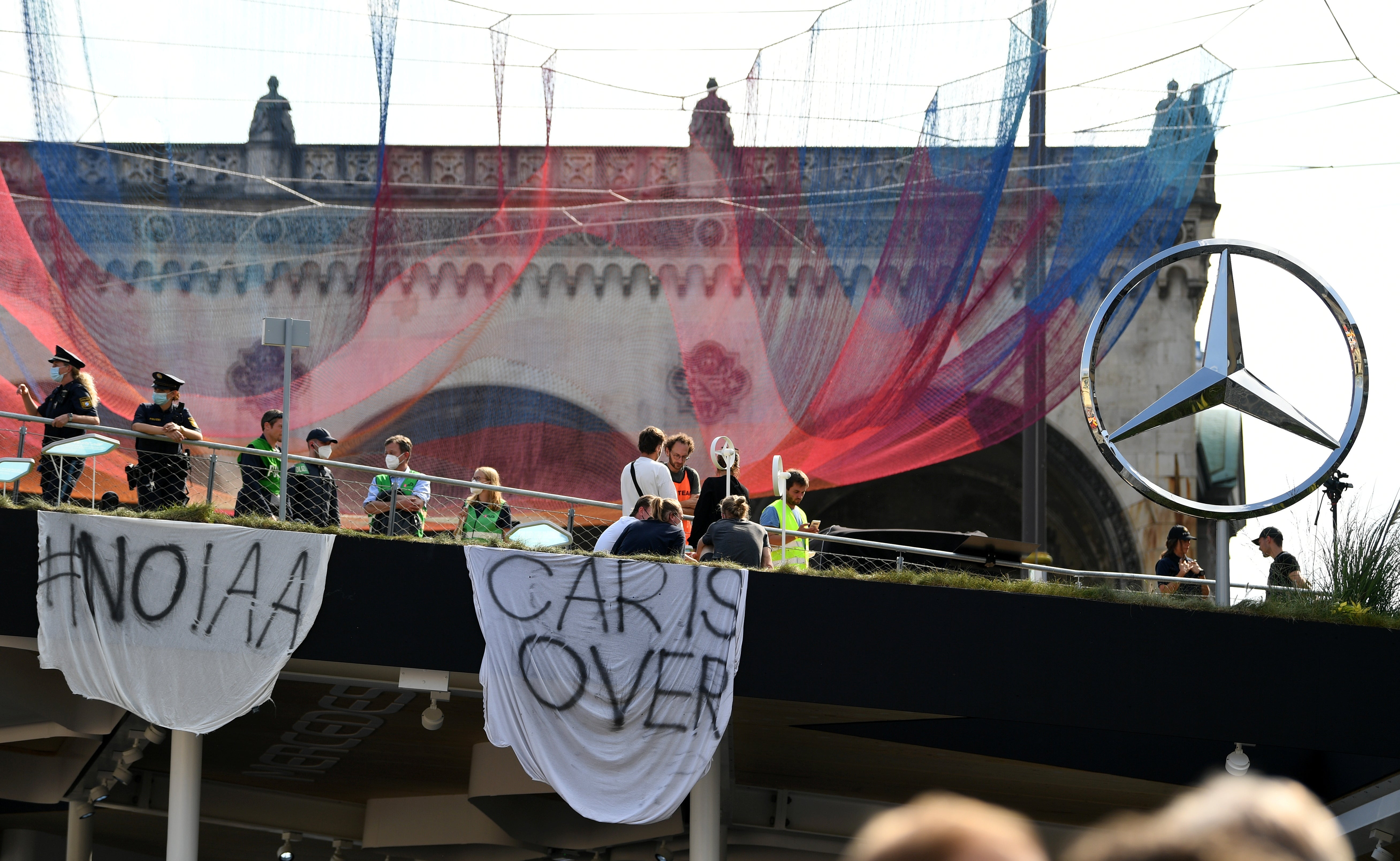 Environmental activists block the Mercedes booth during a protest against IAA MOBILITY 2021