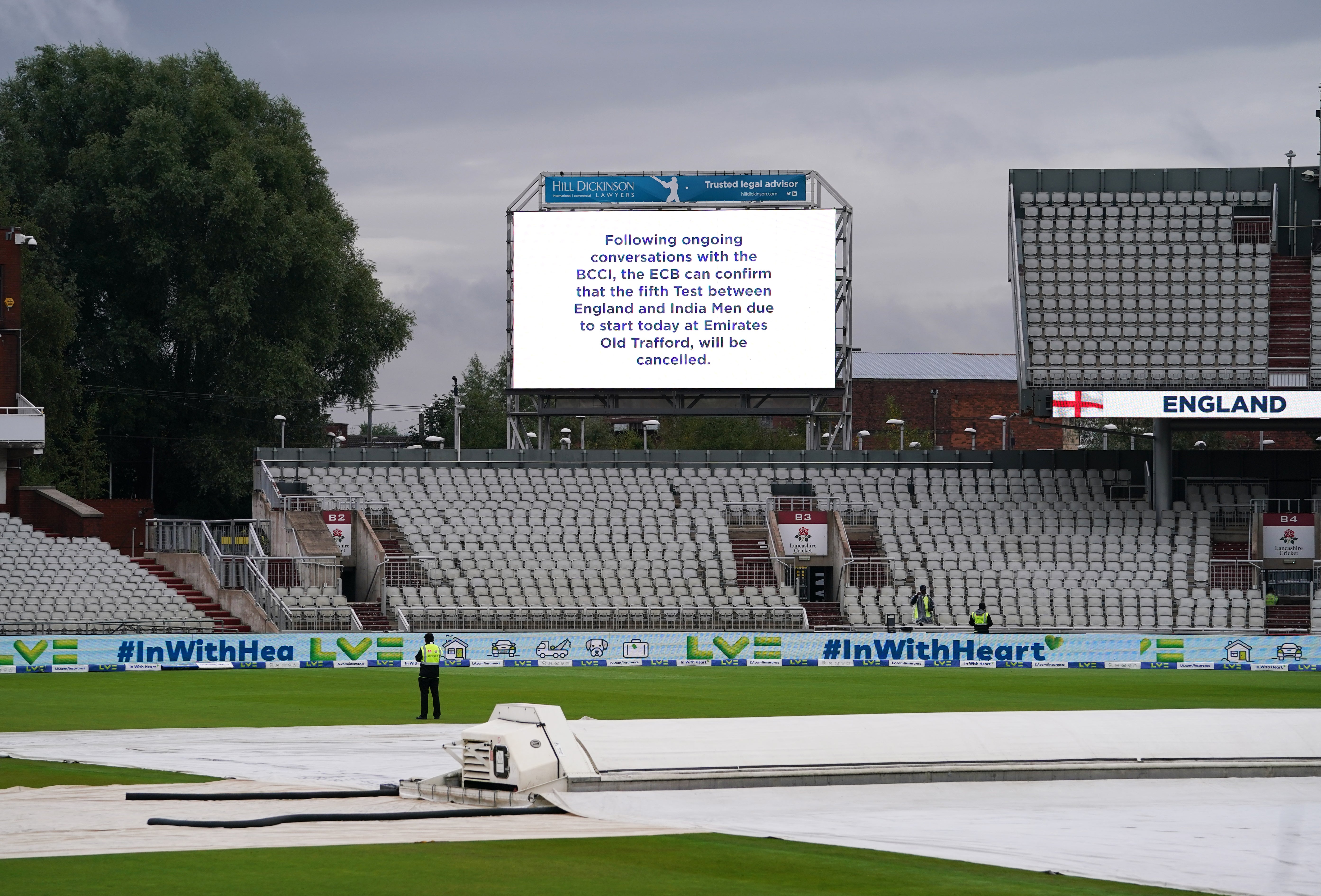 The big screen at an empty Emirates Old Trafford carries the news of the cancelled Test (Martin Rickett/PA)