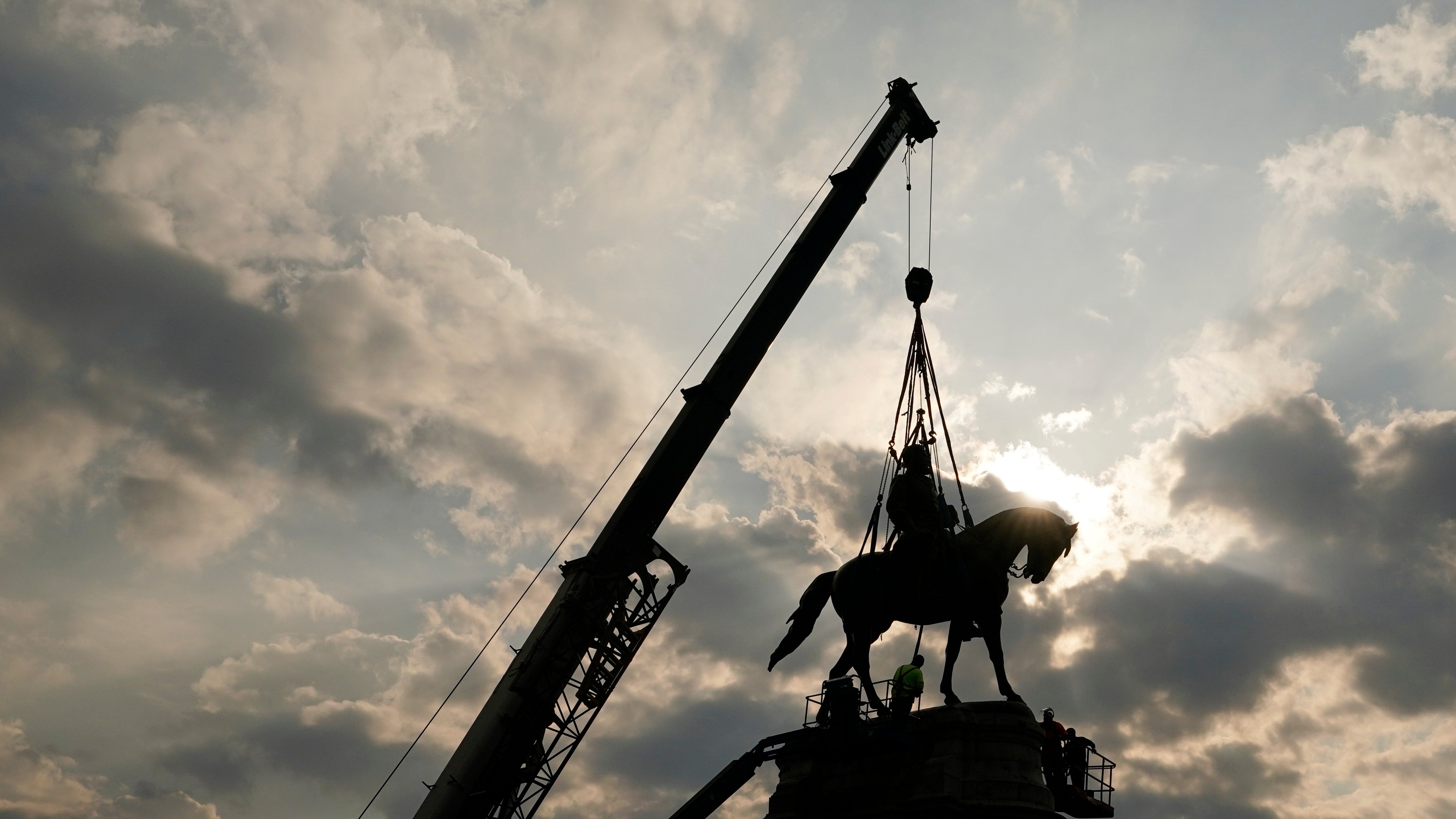 Crews work to remove one of the country's largest remaining monuments to the Confederacy, a towering statue of Confederate Gen. Robert E Lee on Monument Avenue, in Richmond, Virginia.