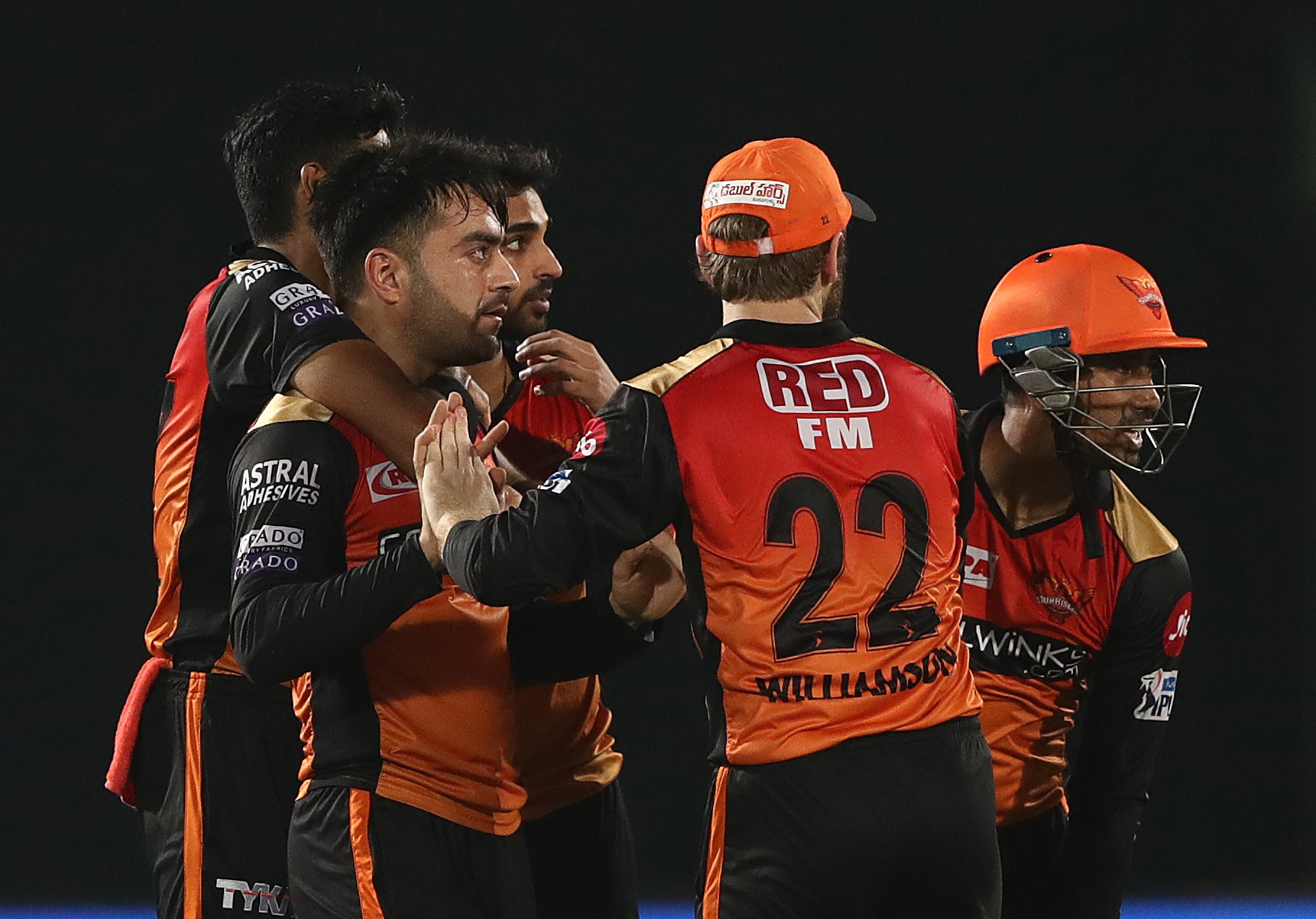 Rashid Khan, left, celebrates taking a wicket