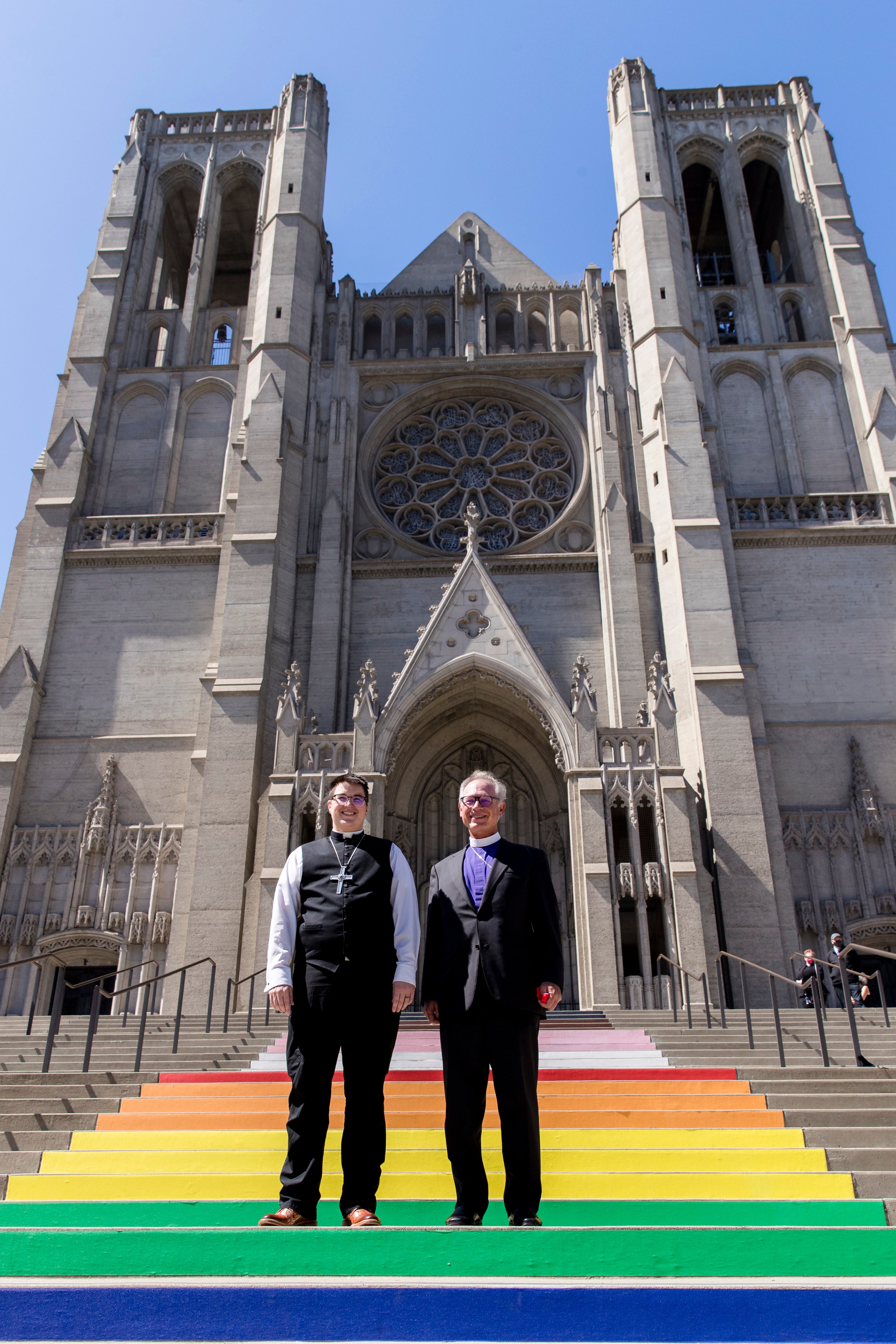 Bishop Megan Rohrer, left, and Bishop Marc Andrus stand on the rainbow steps before Bishop Rohrer’s installation ceremony at Grace Cathedral in San Francisco, Saturday, Sept. 11, 2021